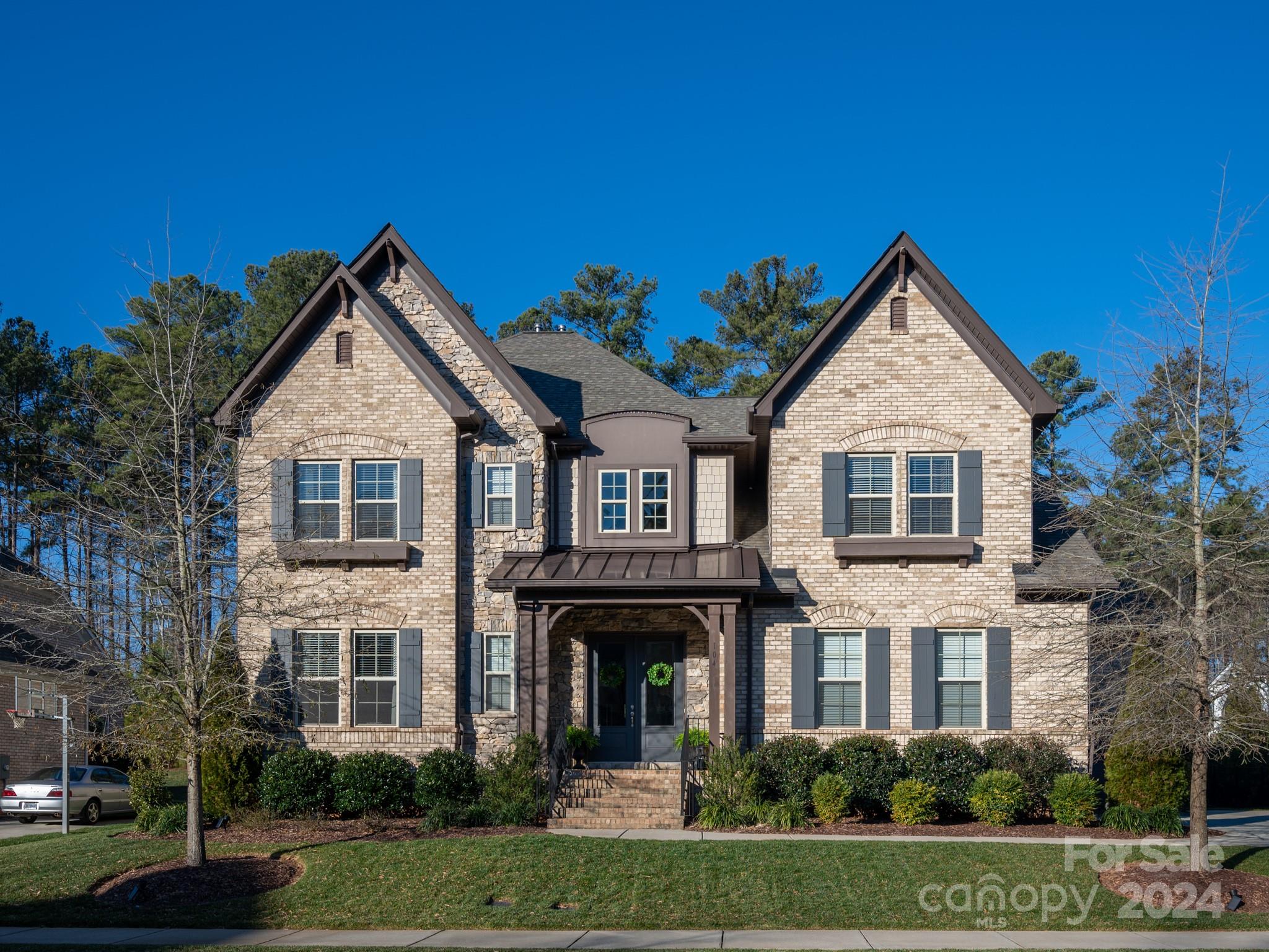 Beautiful move-in-ready home in popular Falls of Weddington community with primary on main, 3 car garage and lovely screened porch. Interior showcases luxury finishes including 5 inch hardwood floors on main including the primary suite, 10 foot ceilings, neutral paint and designer lighting. Gorgeous kitchen features quartz tops, designer tile backsplash, gas cooktop, and a LARGE walk-in pantry. Don't miss the extra cabinet space in the butler pantry. Upstairs features 3 nice size secondary bedrooms all with large walk in closets, 2 full baths, plus 2 large bonus room spaces. Home also includes 2 huge walk in attics! Great private backyard with beautiful tree line and picture perfect grass! Home feels like new!