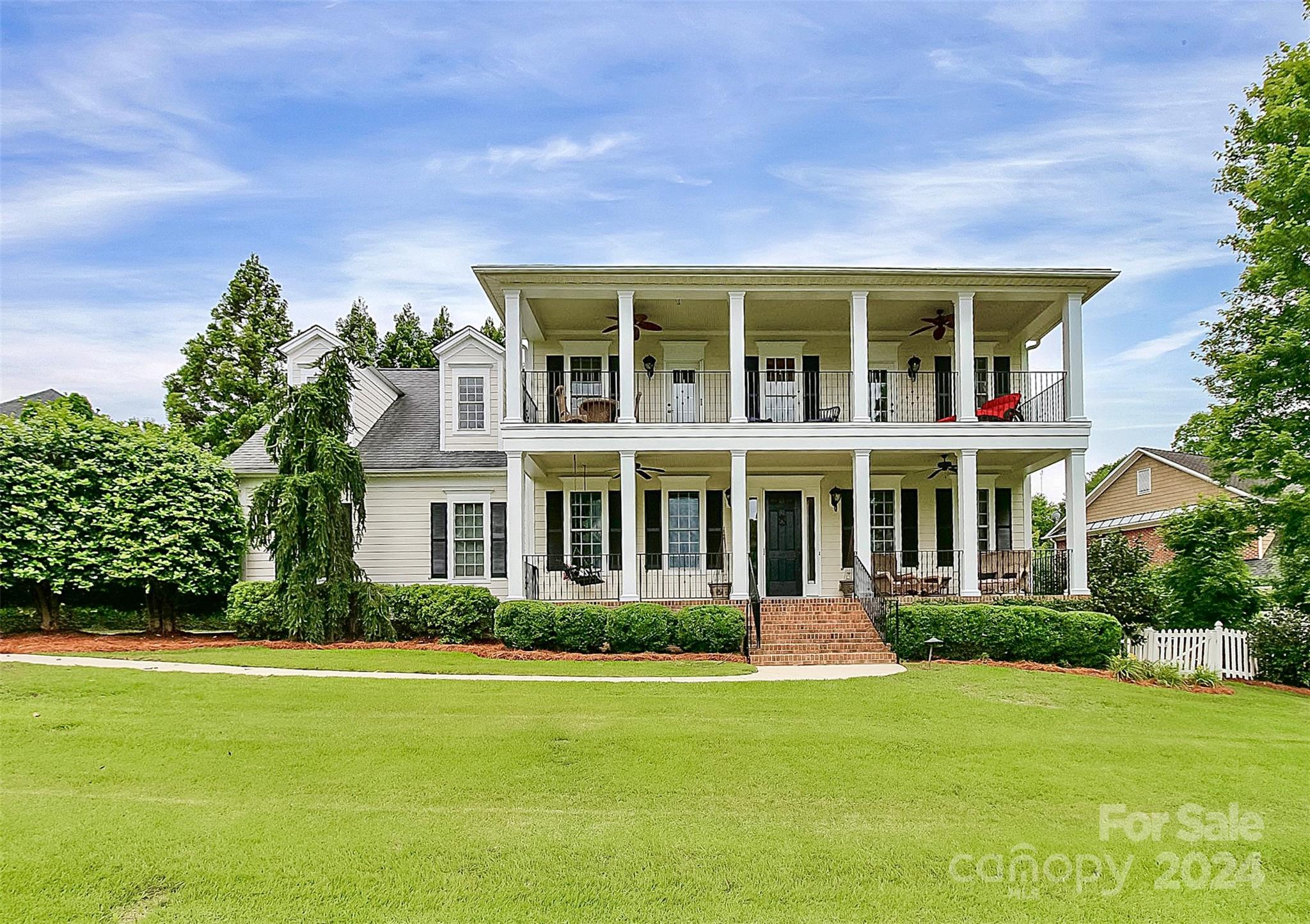 Exceptional custom-built, 2-story home with expansive covered front porches on main & 2nd levels provide year round lake views. This extraordinary home displays distinctive craftsmanship, millwork & meticulous details both interior & exterior. Ceiling accents include coffer ceiling-LR, tray ceiling-primary & decorative design feature-DR. Custom built-ins flank the gas fireplace in FR, beadboard in all baths, powder, rear hall, laundry(with laundry sink), & built-in wood shelving at upstairs hallway leading to primary bedroom. The eat-in gourmet kitchen features custom cabinets w/dental molding, SS appliances, butlers pantry accesses DR & a wall of windows overlooking the professionally designed & landscaped private patio. The generously sized, 2nd level primary ensuite bedroom offers subtle ceiling lighting, separate soaking tub & shower, water closet, walk-in closet, 2 sinks & porch access with water view. Add'l ensuite bedroom level 2. Exterior entry conditioned room not in HLA.