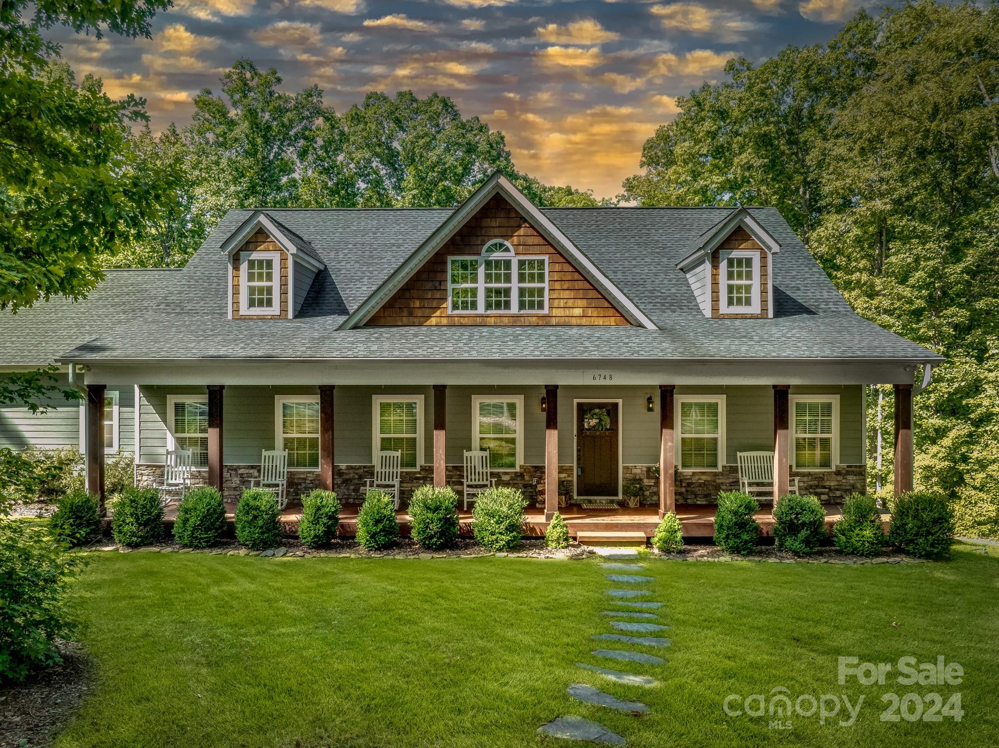 Welcome Home to peaceful country living only 3 miles to Top Rated Clover Schools! Nestled on over 7 acres of breathtaking mature oak trees, this beautiful custom built home sleeps as a 5 bedroom. NEW PRIVATE GATED DRIVEWAY ENTRY ADDED ON 8/24!  A winding trail leads to over 1,500 ft of year-round flowing creek. Enjoy fruit trees, berries, gardens and abundant wildlife including deer & turkey from your private backyard. A must see professionally built dirt track for motorsports fun wraps around a treehouse with climbing wall.  Home features exquisite details, coffered ceilings and a wood- burning fireplace. Beautiful farmhouse kitchen w/ walk in pantry and solid maple faced cabinets. Newly finished upstairs includes a rec room, bedroom, bonus room & full bath. Zoned for New Lake Wylie High School coming in 2026. Just 30 min. to Charlotte & only 10 min. to Lake Wylie. Fenced area for animals. Endless outdoor activities and priceless sunsets right off your private back deck!