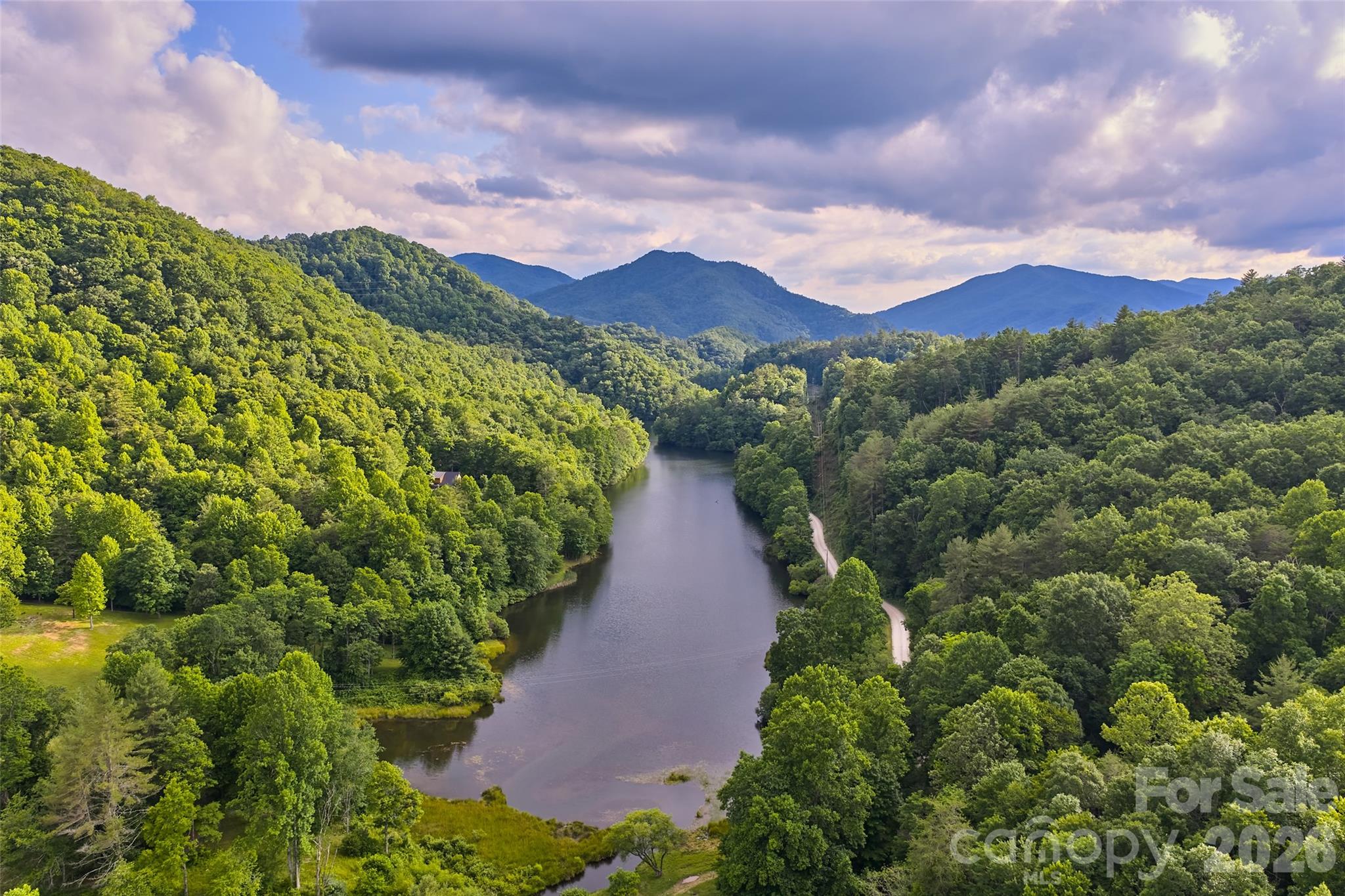 Rare opportunity to acquire a 35-homesite development portfolio within the upscale gated Mystic Lands community of Western North Carolina. Bordering the national forest with access to the Nantahala River and Queen's Lake, this exceptional offering provides builders, developers, and investors the opportunity to secure immediate inventory in an established mountain community known for its natural beauty, outdoor recreation, and unique amenities.

The portfolio consists of 35 individually deeded shovel-ready homesites offered together as a single sale, eliminating the time and expense of assembling parcels individually. Community infrastructure includes paved roads, underground utilities, and established protective covenants with architectural review designed to preserve long-term property values. Inventory includes ridge top lots with expansive views, lots with lake views, and wooded lots nestled by the national forest. It's a great variety to suit a range of home styles and price points. 

Mystic Lands offers an impressive collection of amenities that set it apart from other mountain communities, including the Mystic Forest equestrian facilities and riding arena, stocked pond, miles of scenic walking trails, Mystic Ridge canoe house and lodge, night sky observatory, access to Queen's Lake, and the Mystic River section featuring a riverfront clubhouse and private scenic river islands along the Nantahala River.

Located just minutes from the Nantahala Gorge, Nantahala National Forest, Fontana Lake, and countless outdoor recreation opportunities, the community appeals to buyers seeking primary residences, mountain retreats, and vacation homes. Short-term rentals are permitted, creating additional flexibility and investment potential.

Individual parcel inventory, maps, and supporting documentation are available. Offered as a single portfolio sale. An exceptional opportunity for regional builders, developers, or investors seeking a large-scale homesite acquisition in one of Western North Carolina's premier mountain communities.