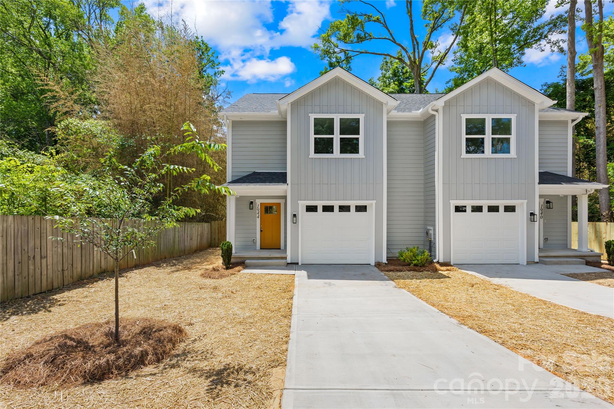 New construction near NoDa, Plaza Midwood, and Uptown under $400K — with a garage, fenced yard, no HOA, and land included. This townhome-style duet offers a smart alternative to a traditional townhome complex. You get modern finishes, a functional 3-bedroom, 2.5-bath layout, private outdoor space, driveway parking, and an attached one-car garage. Inside, you’ll find LVP flooring, quartz countertops, modern lighting, and an open main living area designed for everyday living. Upstairs, the spacious primary suite features a tiled walk-in shower and private ensuite bath. Outside, each unit has its own fenced backyard, paved driveway, and attached garage — giving you more privacy and flexibility than many nearby townhome options. Located less than 5 miles from Uptown Charlotte, approximately 3 miles from NoDa, and under 4 miles from Plaza Midwood, this home gives buyers close-in access without typical NoDa or Plaza pricing. If you’ve been searching for newer construction near Uptown Charlotte with modern finishes, garage parking, outdoor space, and no HOA, this one is worth a look.