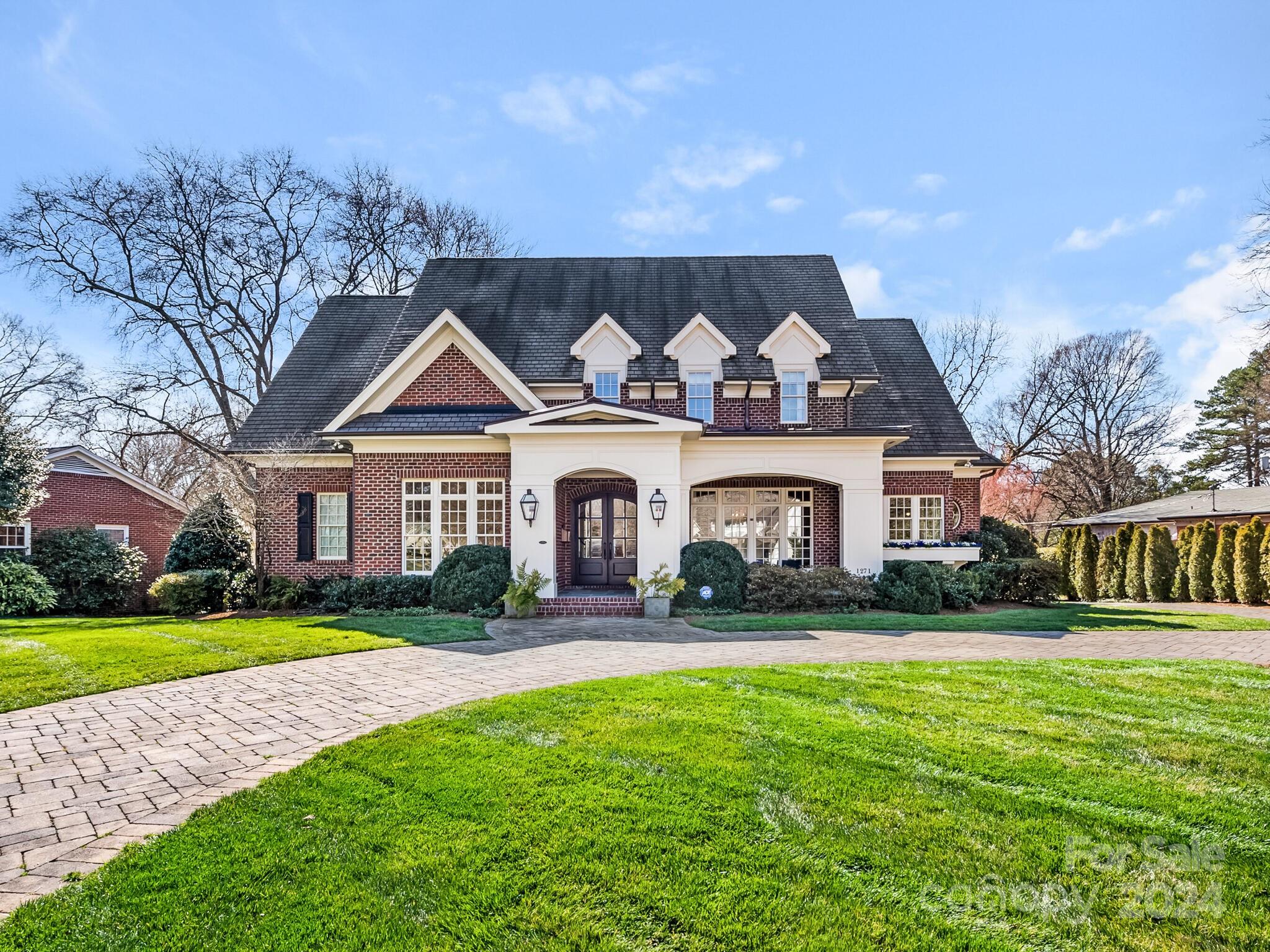 Wonderful home in the heart of Olde Cotswold loaded with detail, charm and curb appeal. Welcoming front porch leads to arched double front entry. Foyer opens to private study with cathedral ceiling and built-in bookcases.  Formal dining room with crystal chandelier. Kitchen with oversized walnut island with prep sink, Wolf gas range, dual ovens, Sub Zero refrigerator. Large walk-in pantry, abundant cabinetry and storage. Breakfast room. Family room with built ins, coffered ceiling leads to screened porch with fireplace. Wet bar with beverage fridge. Private office. Mud room, drop zone. Primary bedroom with tray ceiling opens to porch. Primary bath with heated floors, dual vanities, spacious walk in closet. Upstairs features three additional large, ensuite bedrooms with walk in closets. Huge bonus room with half bath. Second laundry hookup upstairs. Detached 2 car garage with permanent stairs to an unfinished storage area. Fenced back yard. Round stone paver driveway and circular drive.