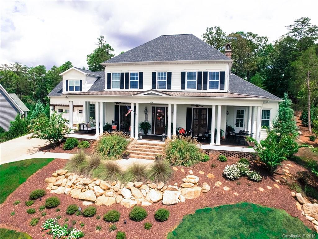 Impeccably finished custom home in Baxter's River District. This meticulously designed property is out of a southern living magazine. 4BR with possible 5th BR or playroom. Home theatre/game room. Gourmet kitchen w/ custom cabinets, exceptional granite, custom butcher block, high-end appliances & brick fireplace. French doors lead to a huge front porch. Downstairs master w/ lux bath & freestanding tub. Barn doors, coffered ceilings, custom built-ins, drop zone cubbies & heavy moulding throughout.