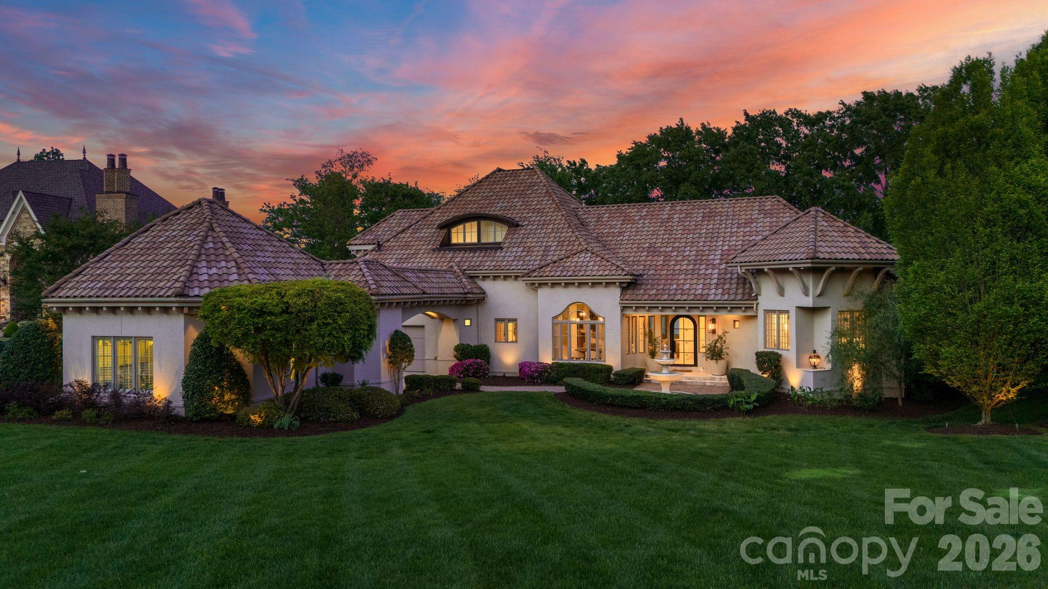 Positioned on one of the most breathtaking waterfront lots in The Point on Lake Norman, 215 Milford Circle exemplifies modern luxury living at its finest. Completely renovated in 2021 and thoughtfully curated with the highest level of craftsmanship, design, and quality, this Mediterranean-inspired estate seamlessly blends timeless elegance with contemporary sophistication. Designed for both grand-scale entertaining and intimate gatherings, the home offers an exceptional open-concept layout anchored by a chef’s dream kitchen featuring professional-grade stainless steel appliances and an expansive family room. Floor-to-ceiling windows and glass doors flood the interior with natural light while framing spectacular main-channel lake views, creating a warm and inviting atmosphere throughout. A private main-level wing is dedicated to the luxurious primary retreat and executive study, offering comfort, privacy, and everyday convenience. A second main-level bedroom with its own en-suite bathroom and direct outdoor access provides exceptional versatility, making it ideal for guests, multigenerational living, a private fitness studio, or a secondary office. Every space has been carefully designed to balance functionality with refined style. Outside, resort-style amenities transform daily living into a true waterfront experience. Enjoy sweeping lake views from the infinity-edge pool and spa, relax beneath expansive covered outdoor living areas, or entertain guests across multiple lounging spaces designed for unforgettable sunset gatherings. A private dock provides direct access to the lake and completes this exceptional outdoor oasis. The upper level features three additional bedrooms, two full bathrooms, a spacious bonus room, a bunk room, and a newly constructed rooftop terrace that captures panoramic views of the water and surrounding landscape. From its expansive living spaces and impeccable design to its unparalleled waterfront setting and designer finishes, no detail has been overlooked. 215 Milford Circle is a true Lake Norman masterpiece where luxury, design, and lifestyle converge.