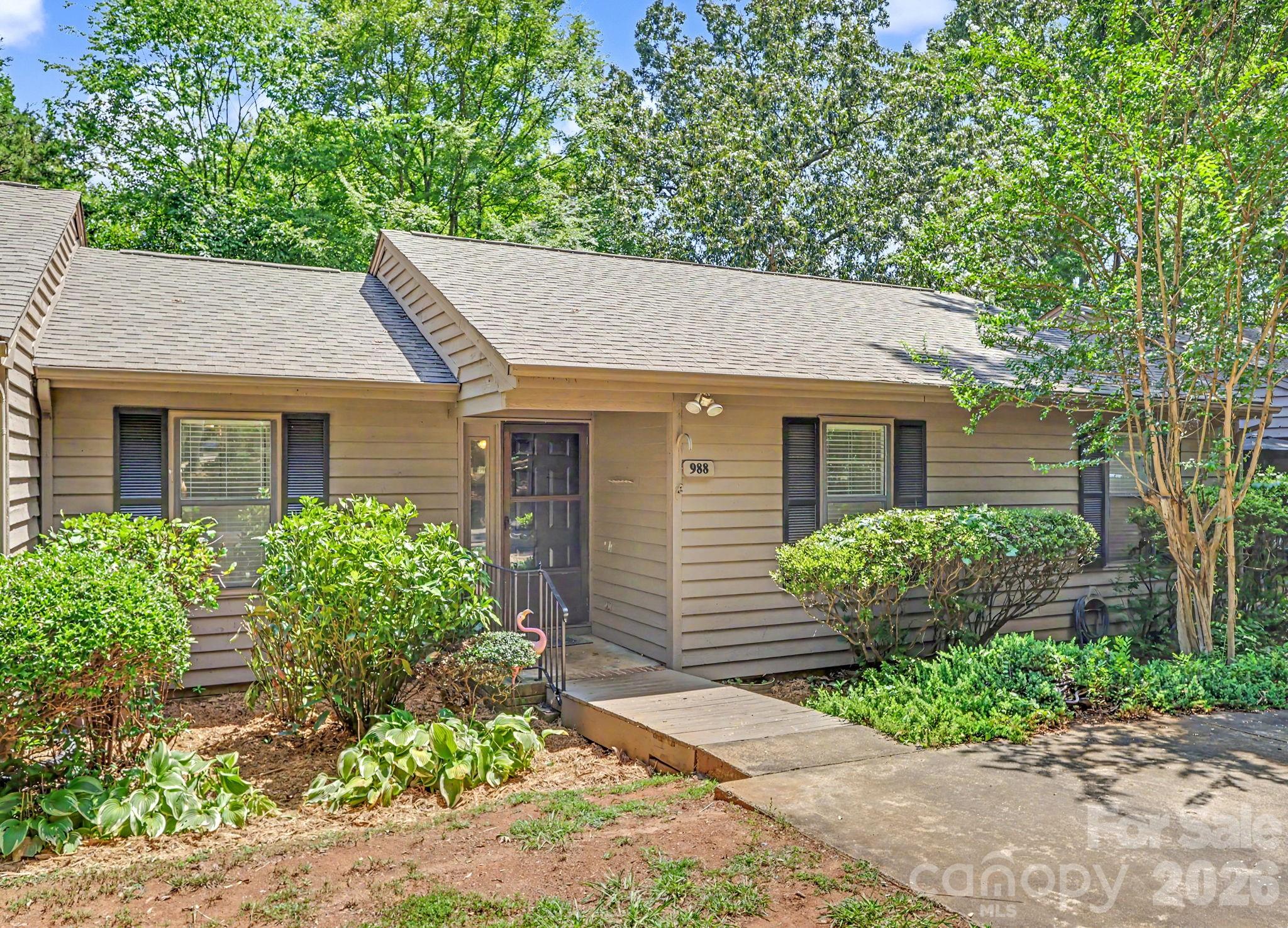 Charming one-level home with LVP flooring, new carpet in the bedrooms, and a spacious living room featuring a beautiful stone fireplace. This 3-bedroom, 2-bath home offers a primary suite with double sinks, a kitchen with breakfast bar, and a dining area overlooking the wooded backyard. Enjoy your morning coffee on the deck. Storage room included, plus the washer, dryer, and refrigerator remain. Perfect as a low-maintenance home or investment property. Conveniently located near I-77, shopping, and restaurants.