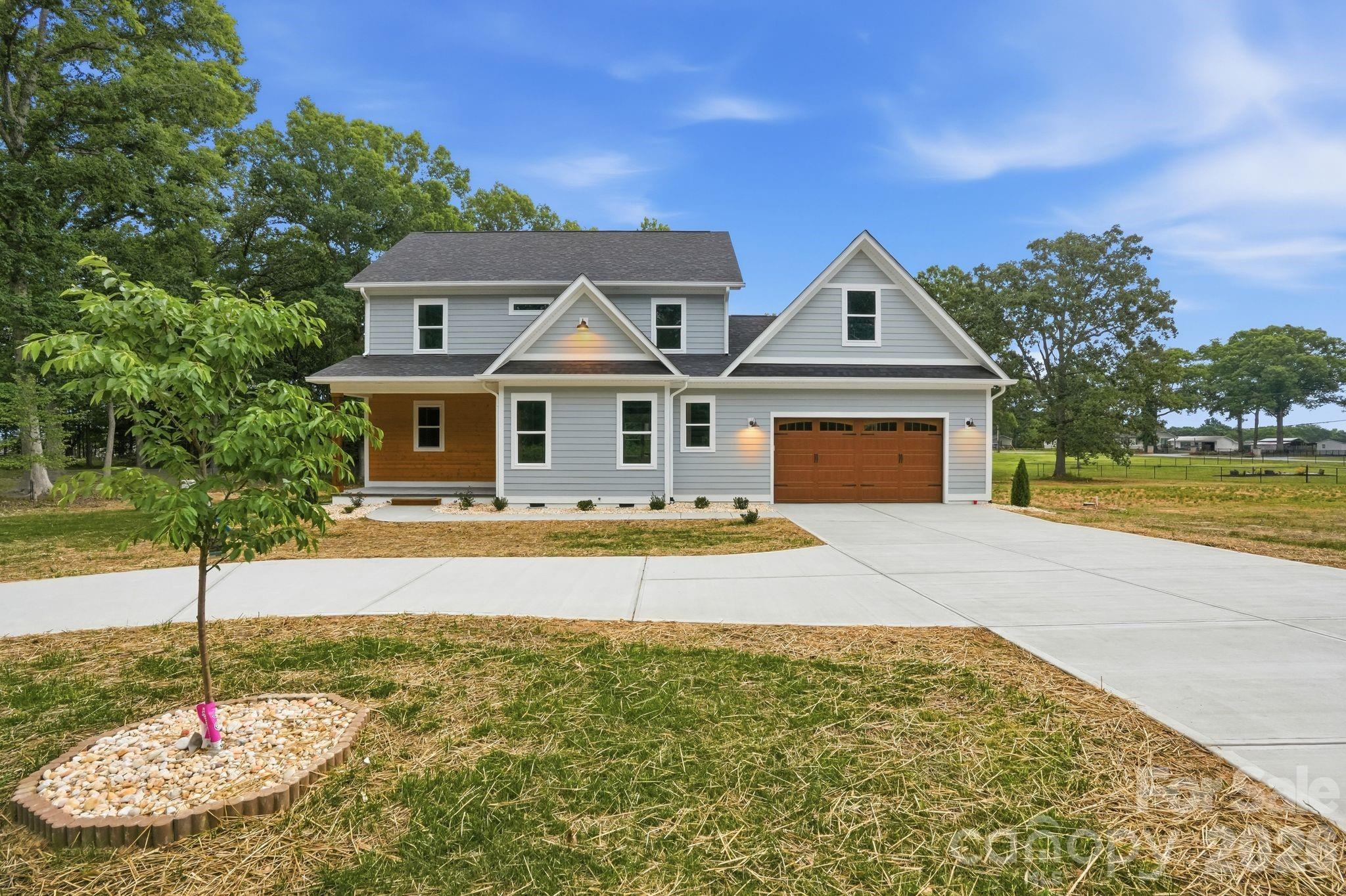 Beautiful new construction home located at 3210 Highway 205 with quick and convenient access to Monroe, Charlotte, Marshville. This spacious home features a well-designed open floor plan with high-quality finishes throughout. The main level offers 9-foot ceilings, a vaulted living room ceiling, a large kitchen with soft-close cabinets and drawers, decorative glass upper cabinets, breakfast area with sliding doors with access to the rear porch, and a laundry room with sink and workspace. The primary suite is conveniently located on the main floor and includes  access to the rear porch, a large closet, and an extra closet and a luxurious bathroom. Upstairs features a Big loft area, 2 additional bedrooms, a full bath, and 1 extra room suitable for a bedroom, office or studio. Additional highlights include quality flooring, spacious covered rear porch and front porch, a patio , septic installed, well installed. Giant garage with high ceilings and attic storage, and plenty of outdoor space around the home.The home also features a concrete driveway with a circular driveway, providing added convenience and curb appeal. A great opportunity offering comfort, space, and convenient location.