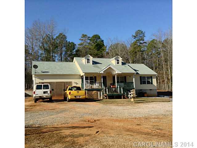 Lovely one level custom built 3BR/2BA. Features: 3/4 pre-finished hardwood flooring, almost an acre fenced, rocking chair front porch, with 22X26 workshop/garage, almost 1500 square feet. Lots of closets and storage. Builder lives in home but has not been able to finish cabinets. Needs TLC to finish cabinets and drawers in the home. Also needs garage door.  Priced based upon current condition.