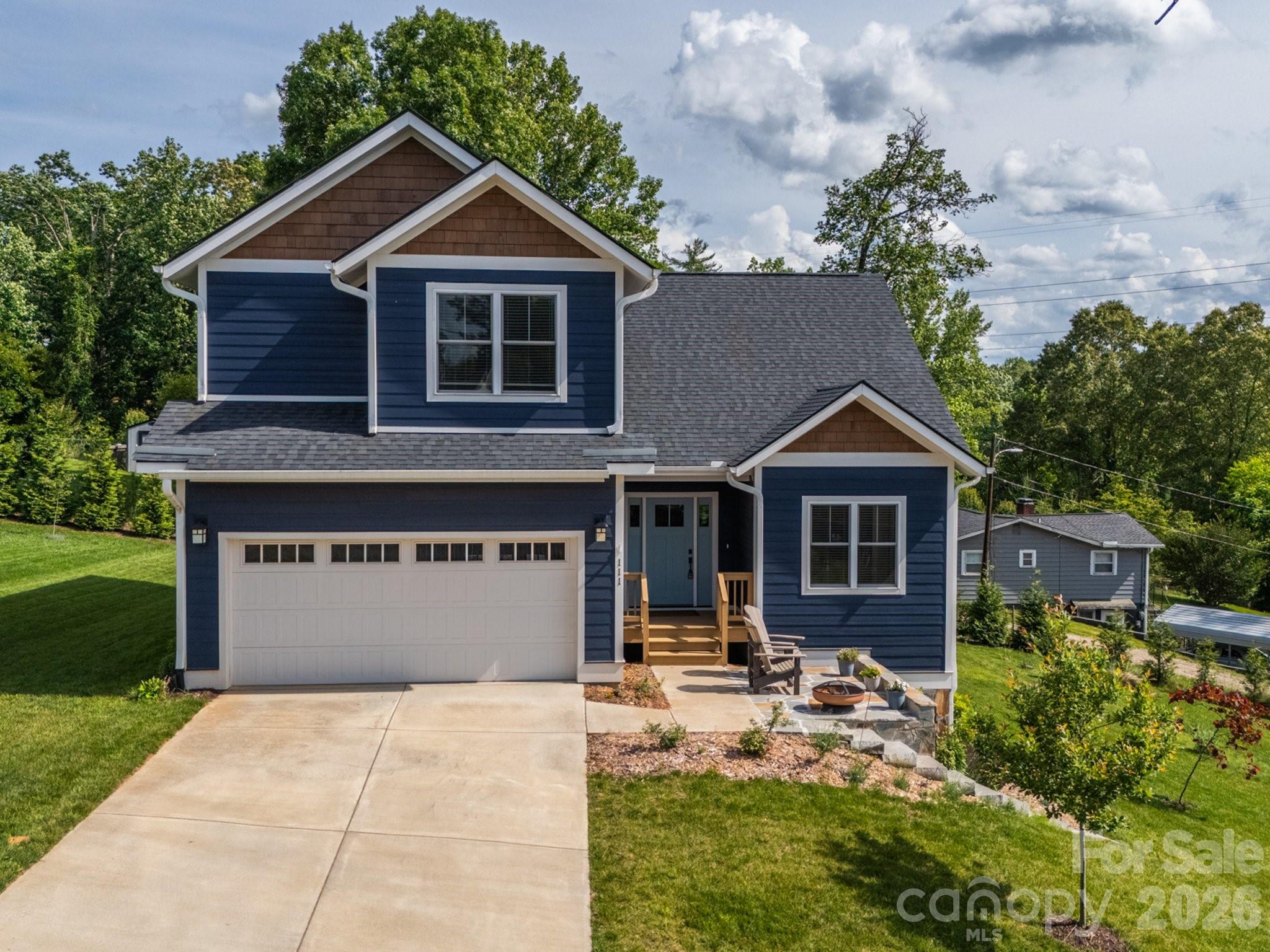 Welcome home to this nearly new gorgeous home that places you just minutes from the vibrant dining, boutique shopping, and scenic greenways of Biltmore Park. with the arts, culture, and mountain adventures of Asheville right at your doorstep. Thoughtfully designed and filled with natural light, this home welcomes you with gleaming hardwood floors, soaring ceilings, and an open, airy floor plan that lives beautifully for both everyday life and entertaining. The kitchen features granite countertops, a breakfast bar, and a generous pantry that keeps everything organized and within reach. The primary suite on the main level is your personal sanctuary with a spacious ensuite bathroom and an expansive walk-in closet that truly delivers. Upstairs, a large bonus room adapts effortlessly to your lifestyle, whether you need a home office, media room, or guest retreat. Two additional bedrooms and a full bath round out the upper level beautifully. Enjoy easy outdoor living with a covered back deck for quiet mornings or evening gatherings, plus a charming flagstone patio out front to soak in the sunshine. A two-car garage adds convenience and ample storage. With thoughtful finishes throughout, this home is as move-in ready as it gets with no projects, no worries, just pure WNC living. All just moments from dining, shopping, and greenways, with downtown Asheville and endless outdoor adventure close at hand. Schedule your showing today!