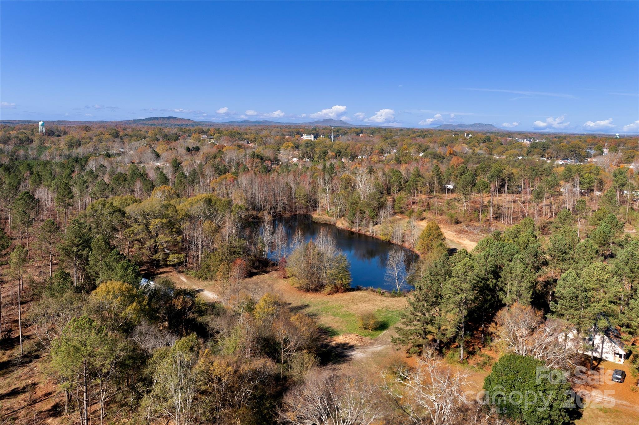 Picturesque country living at its finest. 15.887 Acres in the highly desired Clover, SC with a pond! With mature timber and a pond, this large lot helps create a peaceful homestead and country lifestyle while being minutes away from modern amenities. The best homesite sits among the mature oak trees over looking the pond. Public Parks, Main Street Clover, Lake Wylie, award winning schools, are all close by; very centralized to everything you need! Easy access to Charlotte, Fort Mill, Rock Hill and York.  If you are looking for a peaceful homesite for your custom home, this is the land for you! There are electrical utilities available at the street. Spectrum broadband internet is available on Tom Joye Rd. With the large lot size, pursue building your dream home, family compound, use this land for your small farm and other gardening activities.  *More land available for sale* RMX-20 zoning, no manufactured homes. Conventional Septic can be installed. Deferred property taxes available.
