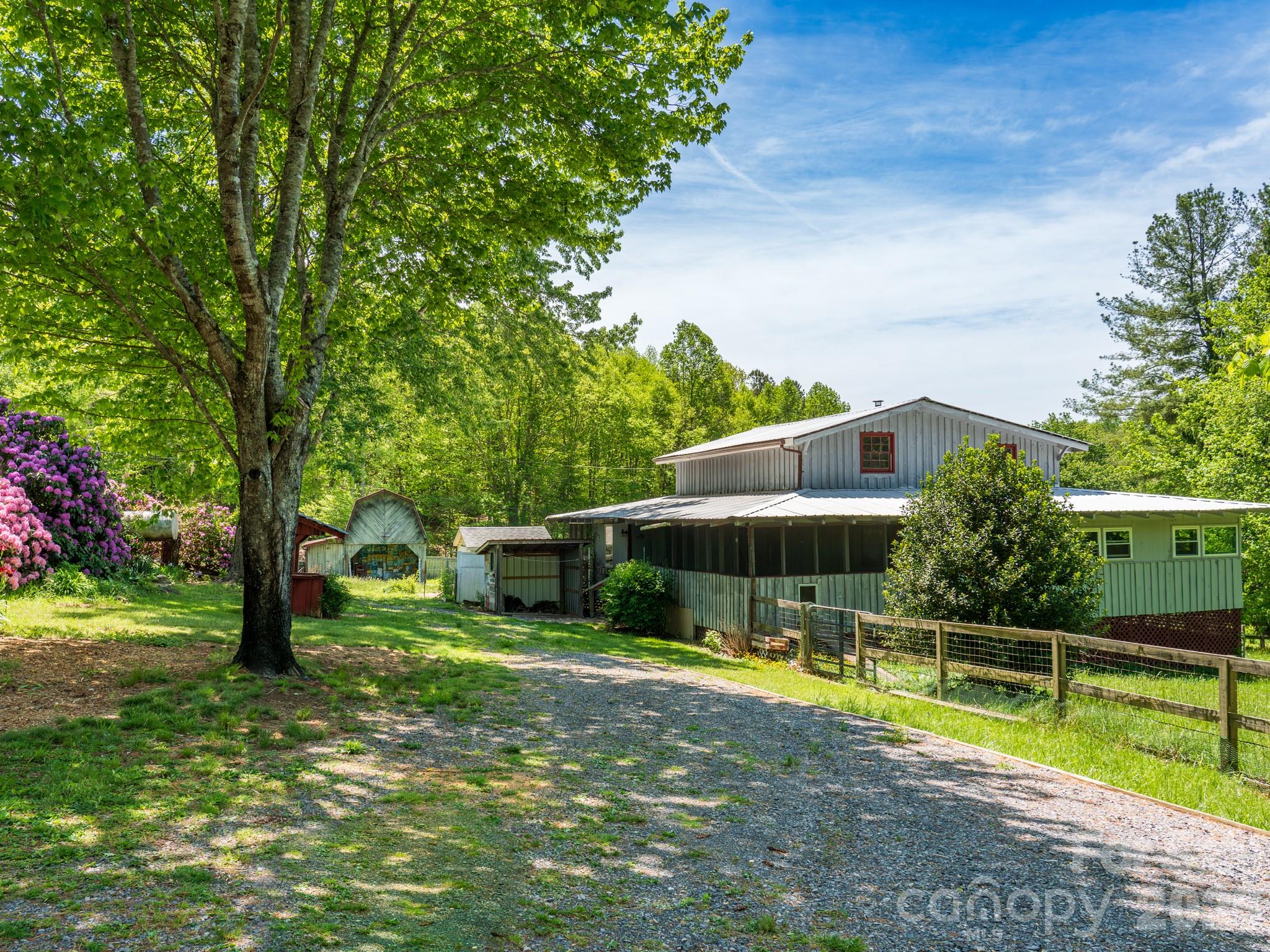 This NC mountain home, in the heart of Hidden Valley, is the perfect place to put down roots for your family homestead. With a memorable mountain cabin surrounded by 1.4-acres of flat yard and a fenced in pasture featuring a beautiful vintage barn, you'll have plenty of room for your family, your animals and your garden to grow! With solid bones and a highly desirable setting -- including deeded recreational access to the communal Hidden Valley pond -- it's ready for you to live the cottagecore country life you've been dreaming of! 

This property also presents a prime opportunity for those looking to renovate, flip, or create a custom mountain retreat. The land is a standout feature—fully fenced pastures offer flexibility, while the vintage barn adds character and potential for restoration, storage, or creative repurposing. And if you're looking to modernize the existing structure and maximize value with a full remodel, the possibilities for a profitable flip here are wild! 

Located at 3,220' in elevation in a peaceful, scenic subdivision surrounded by family farms and large tracts of conservation land. With easy access to nearby amenities in Waynesville, Canton and Asheville as well as the Great Smoky Mountains National Park and Pisgah National Forest this property is the ideal location to bring your vision to the mountains and unlock the potential this property has to offer!
