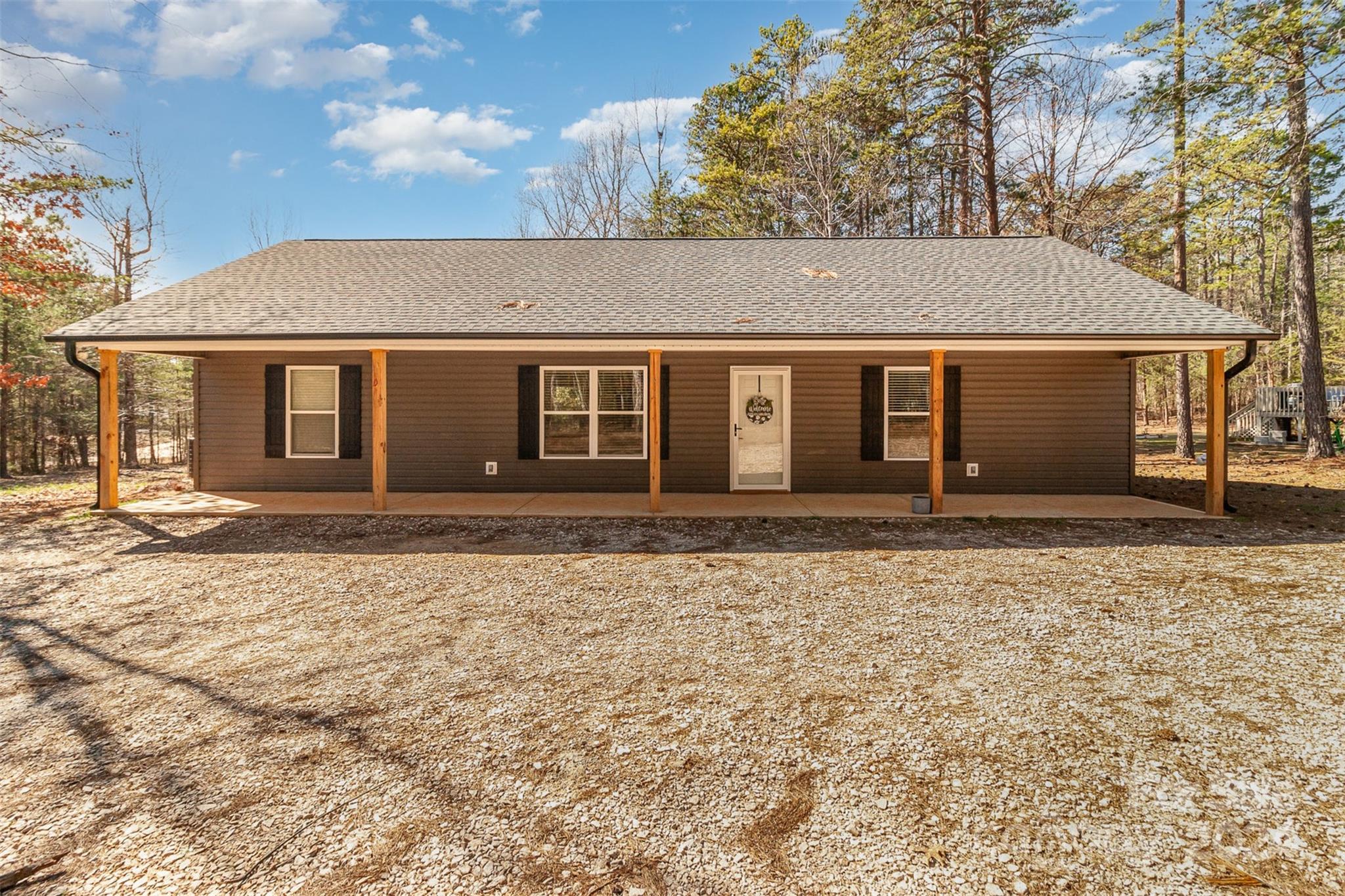Come check out this beautiful like new ranch home on the outskirts of Hickory Grove, SC. Large, level lot with wooded areas in front and back just under an acre. Open floor plan includes family room, dining area, kitchen with stainless appliances and granite counters. Luxury vinyl plank flooring throughout. Owner's suite includes spacious walk-in closet, and private bath with dual vanity with granite counter. Both additional bedrooms feature spacious walk-in closets. Hall bathroom also features vanity with granite counter. Separate laundry room. Covered front and back porches. Storm doors on both front and back doors. Chicken Coop with 5 laying chickens available. Limited traffic neighborhood with a paved street with easy access to Sharon, York, Clover and Blacksburg.