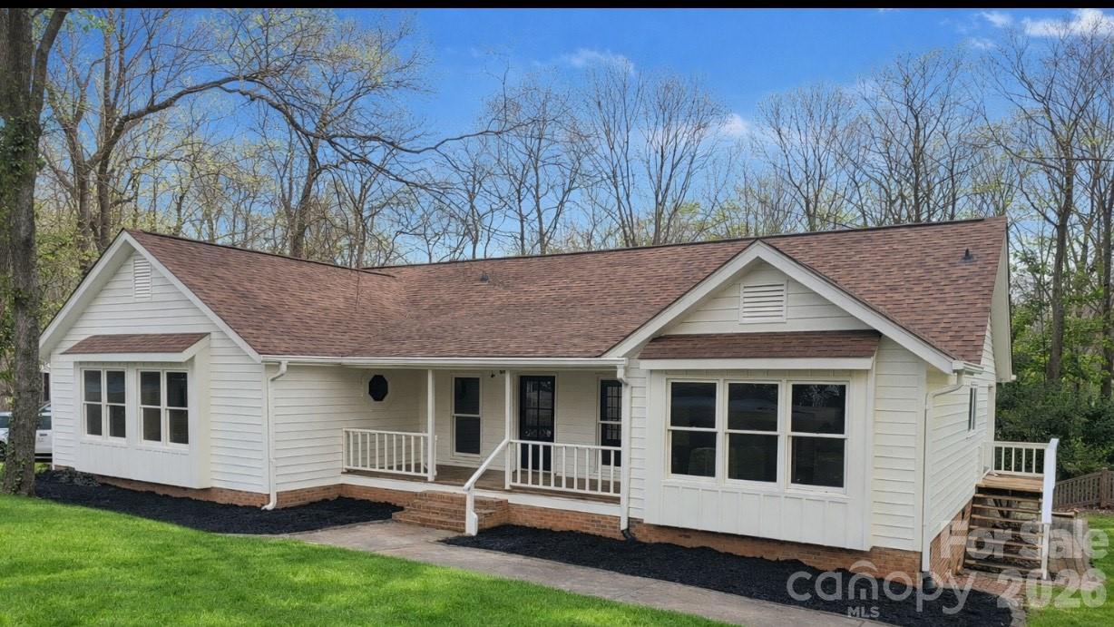 Beautifully renovated and impeccably maintained home in a charming neighborhood. Enjoy abundant natural light, a spacious front porch, and thoughtful custom details. The cathedral living room features floor-to-ceiling windows, a fireplace, built-in wood cabinetry, remote skylights, and French doors opening to the expansive back porch. The bright kitchen offers a gas range, pantry, built-in desk, large windows, cozy window seating, and an additional set of French doors. The spacious primary suite easily accommodates a king bed and includes built-in window seating, an en-suite bath with separate tub and shower, and generous closet space. Additional highlights include new flooring throughout, a separate laundry room, flexible dining/office/4th bedroom space, a built-in dog door, and a converted crawlspace with workshop, garage-door access, and an outdoor bathroom. The back porch overlooks the inground pool, with a bridge leading to a private, flat backyard full of potential.