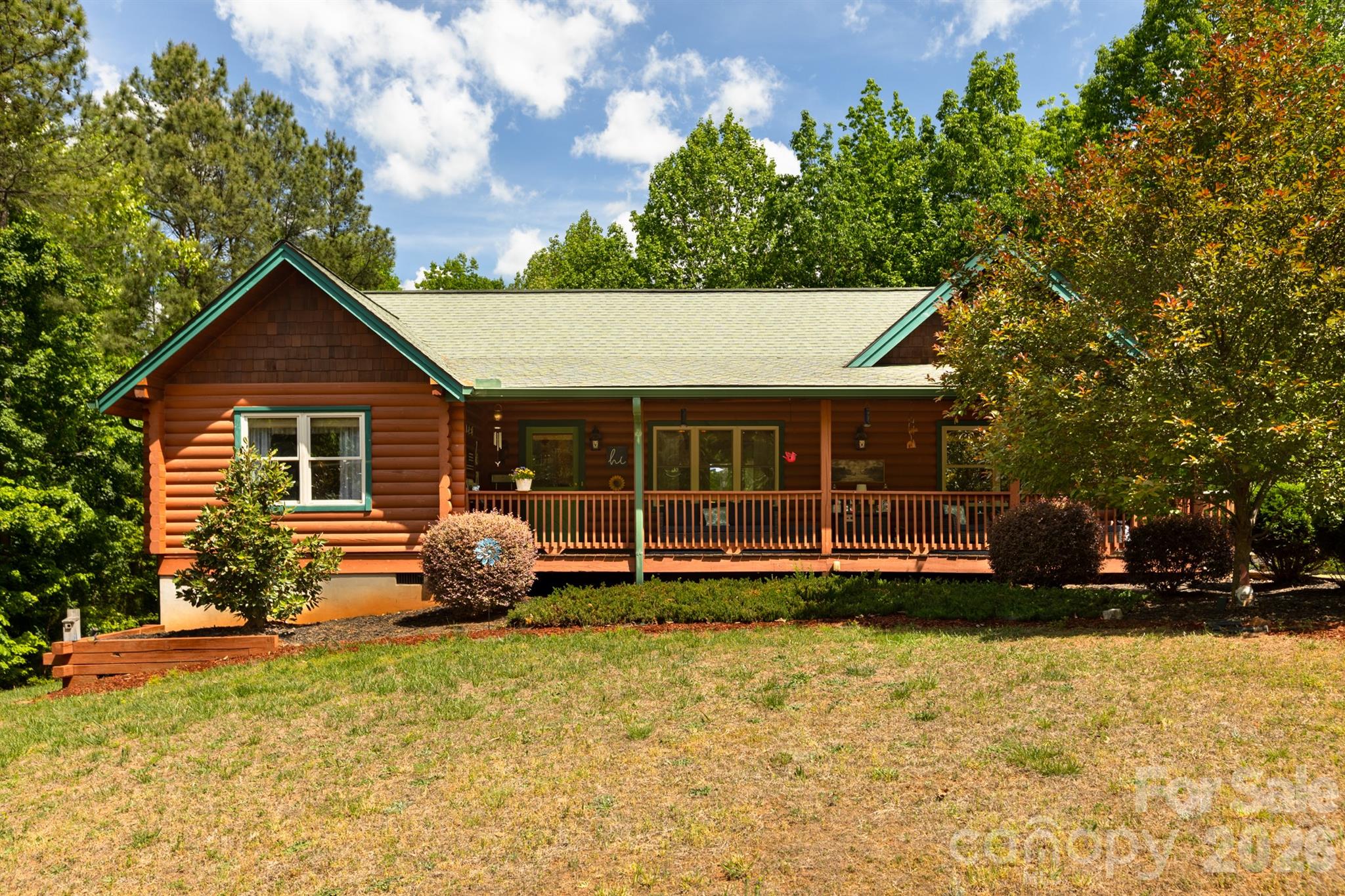Located on top of a mountain in a gated community, this could be your dream log cabin retreat, investment property or primary residence! This one-level cabin, on a 1-acre mostly level lot, is part of Yellowtop Mountain Estates. Once you’re behind the gate you make your way up to the cabin with some of the most gorgeous mountain views. When you arrive at the home you step inside an open-concept layout that seamlessly integrates the living, dining, and kitchen areas into one beautiful space. This floorplan creates a smooth flow for daily living and entertaining. There is no shortage of rustic charm with the beautiful hardwood flooring and log cabin finishes. In the kitchen you’ll find a huge bar and granite countertops that provide plenty of space for hosting or prepping. For added convenience enjoy a gas stove to cook with. The split floorplan gives you and your guests good privacy with the primary bedroom situated on one side of the home with the two additional bedrooms and extra bath on the other side of the common areas. In the primary bedroom you have a vaulted dormer window for added light. It features an ensuite bathroom and a nice size closet. There is also a separate laundry room off of the kitchen. Behind the home you’ll find the grassy yard, a large powered outbuilding with a freezer and garage door opening. There is also a ready-to-go hot tub platform with power. 

Step outside to enjoy nature from either the long covered front porch or relax on the back deck, perfect for grilling or your morning coffee. Whether watching wildlife or stargazing, enjoy mountain life in this beautiful setting loaded with outdoor fun! Nearby are several camping areas, game lands, lookouts and trails. Jellystone Park is less than 20 minutes away, Lake James and Lake Lure are both around 45 minutes away and for shopping Forest City is a short 20 minute drive. Come make this cabin yours today!