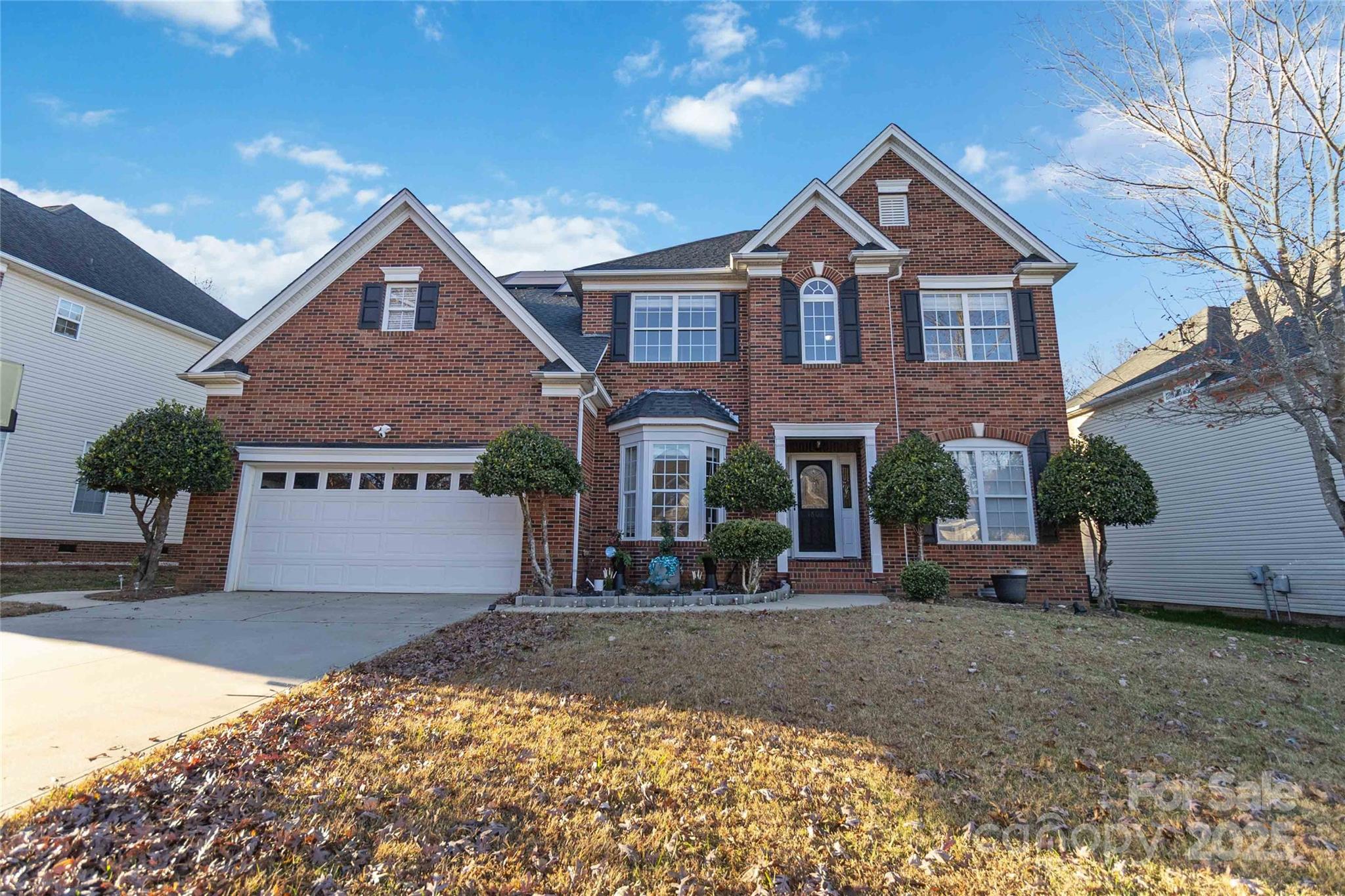 Welcome home to Fountaingrove! Gorgeous 5/3 partial brick with all major components recently upgraded. Tech enabled home features EV charger, auto solar blinds, wi-fi enabled sprinkler system and Tesla solar panels. 2-story foyer with open floor plan, hardwood flooring, crown molding, built in book case w/modern fireplace insert. Main level features full bed and bath.  HVAC upstairs/down, Gas water heater both replaced in 2022. Architectural shingle roof replaced 2017. Owner's bedroom oversized 20' x 14' w/ garden tub, dual vanities and custom closet organizer. Walk or skip to Trader joe's. Playground/pool area... Fantastic location near all mallard creek!