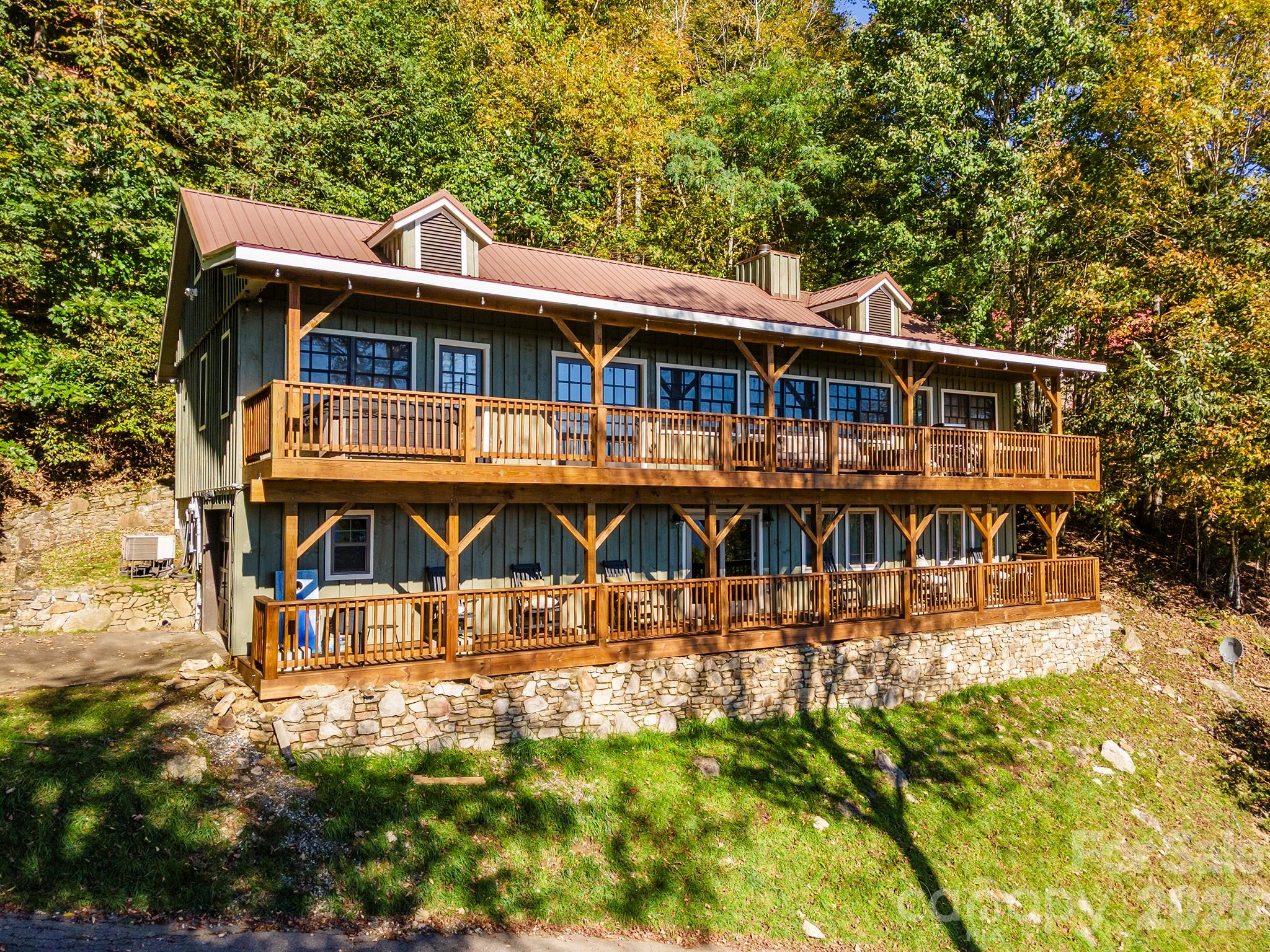 3 Full Bedrooms plus Bunk Room! Offered FULLY FURNISHED, this stunning mountain retreat sits at an elevation of 4,400 feet and captures breathtaking long-range views from two expansive 58-foot covered porches! Trendy finishes and furnishings of this home blends upscale comfort with the serenity of the Blue Ridge Mountains. Nestled within the secure, gated community of Wolf Laurel, you’ll find a beautifully refreshed interior featuring a newly rebuilt deck, upgraded appliances, remodeled living spaces, a full exterior repaint, and an enhanced septic system. The flexible lower-level room has served as an office, game room, and guest suite, offering endless possibilities for how you live and host. Wolf Laurel offers 24-hour security and an impressive list of amenities including a heated outdoor pool, tennis and pickleball courts, a community pavilion and clubhouse, trout pond, picnic areas, and scenic hiking trails. Seasonal activities such as skiing, snowboarding, tubing, zip-lining, and horseback riding are just minutes away, while optional golf and Country Club membership provide even more ways to enjoy the mountain lifestyle. Located about 35 minutes from Asheville and only two miles from the Appalachian Trail, this home delivers a perfect balance of luxury, nature, and convenience! Currently utilized as a vacation home and profitable short-term rental if buyer is looking for an income producing property!