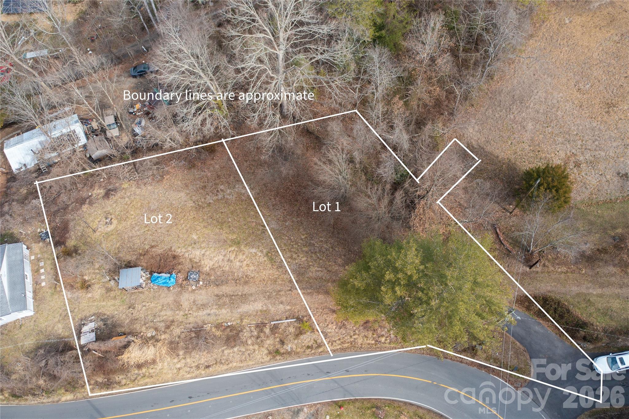 Perched on a scenic knoll in the heart of Woodfin, this exceptional residential lot offers the rare opportunity to build your dream mountain home in a location that perfectly balances serenity with urban accessibility. Situated literally around the corner from the Lookout Mountain Loop Trail and the stunning vistas of the Lookout Observatory, your front door serves as a gateway to some of the area’s most beloved outdoor adventures. Despite the tranquil, high-elevation feel, you are only minutes away from the peaceful Asheville Botanical Gardens and strategically positioned between the creative energy of the vibrant River Arts District and the world-class dining and entertainment of downtown Asheville.
The property’s elevated position on a natural knoll ensures you’ll enjoy breathtaking, year-round mountain views, providing a constant reminder of why you chose the Blue Ridge lifestyle. This lot is the ideal canvas for your custom home, designed for those who want to be close to everything while feeling miles away from it all.
For those seeking even more space or seclusion, an additional adjacent lot is also available (MLS# 4349770). This unique opportunity allows you to expand your footprint for a larger house, create an expansive private yard, or simply secure an extra buffer of privacy to protect your investment. To ensure seamless development and connectivity, the seller will grant a private access easement from Lot 1 to Lot 2. Whether you are a builder looking for a prime location or a homeowner ready to plant roots in one of Woodfin’s most desirable pockets, this land offers the views, the location, and the flexibility to make your vision a reality.
Lot will require private easements to obtain sewer service.