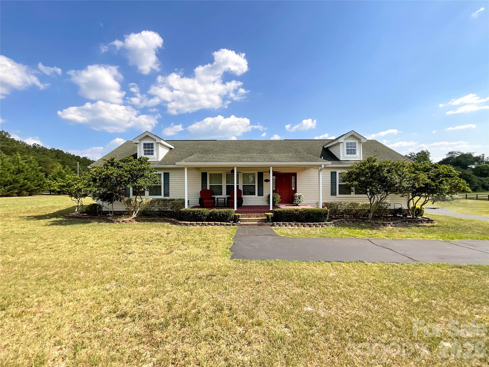 Discover peaceful country living at 1132 Sandhills VFD Road in Jefferson, South Carolina. This well-maintained 2010 single-story ranch home offers 2,206 square feet of comfortable living space with 3 bedrooms, 2 full baths, an open-concept kitchen featuring oak cabinetry and an island, a cozy fireplace, and easy-flowing living areas. Situated on a beautiful 6-acre corner lot with full fencing and multiple cross-fenced pastures, the property is a true equestrian paradise complete with a large barn featuring horse stalls, riding arena, tack room, and direct pasture access. Additional highlights include a sparkling above-ground pool with a spacious red composite deck overlooking the pastures, an attached 2-car garage, and plenty of room for animals or outdoor enjoyment. Conveniently located just minutes from Jefferson’s local amenities, about 8 miles from Pageland, 16 miles from McBee, and roughly 50 miles southeast of Charlotte, NC, this home provides the perfect balance of rural tranquility and easy access to shopping, dining, entertainment, and urban conveniences.