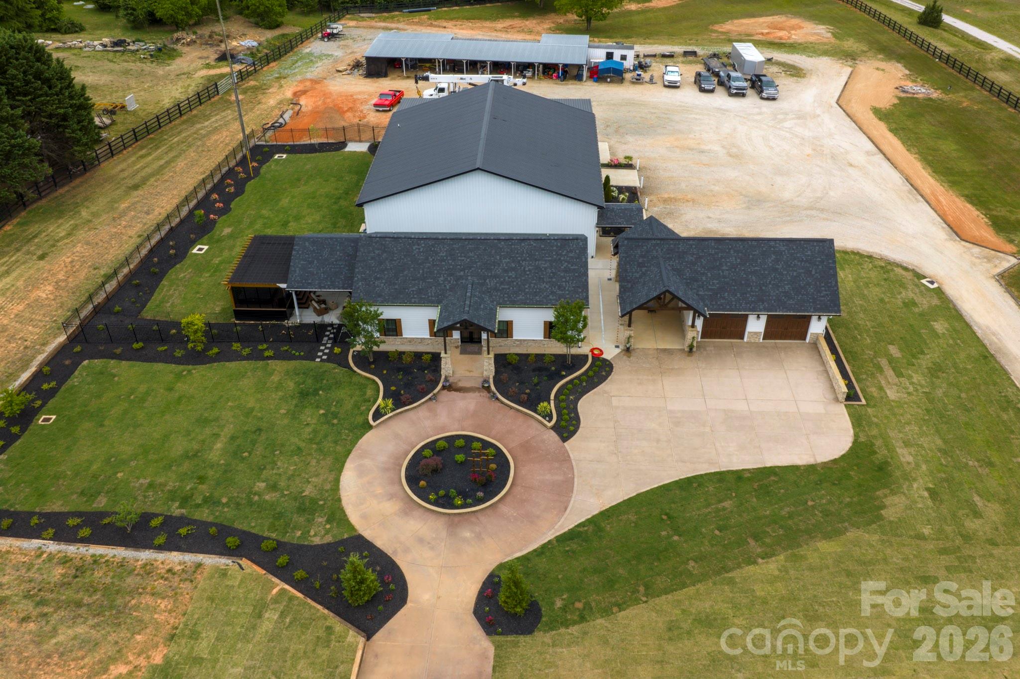 Welcome to 1830 Dulin Road — a thoughtfully designed modern farmhouse cottage set on 4.65 fully fenced acres, offering the perfect blend of comfort, function, and versatility. 

Think Luxury Barndominium.

Over 4,312 square feet of heated living areas. 

Built in 2025, the 1,500 sq ft main home features an open-concept layout seamlessly connecting the kitchen, living, and dining areas. The kitchen is equipped with solid surface countertops, pull-out drawer storage for pots and pans, and a spacious pantry with custom pull-out shelving. Throughout the home, you’ll find custom stamped concrete “wood-look” floors, combining durability with rustic charm.

The primary suite offers a spa-like retreat with a standalone soaking tub and separate shower. This 3-bedroom, 2-bath home also includes attic storage, a private covered patio with swim spa, and professionally designed landscaping, complete with lighting and irrigation. The property is supported by a well and 2 septic systems enhanced with concrete French drains and 20,000 sq ft of Bermuda sod. The entire property is fenced in. 

In addition to the home, the property features an impressive 4,800 sq ft insulated shop, ideal for business, hobbies, or storage. The shop includes three bays with 14’ doors, a dedicated RV bay with waste dump, mezzanine level with office space and storage, and both upper and lower half baths. The space is fully heated and cooled, with LVP and tile flooring throughout.

A private guest suite of approximately 900 sq ft offers even more flexibility, complete with full kitchen, bath, laundry, separate septic system, one bedroom, and custom epoxy flooring — perfect for guests, rental income, or multi-generational living.

Additional features include a detached custom garage with two enclosed bays and one carport, engineered lean-to storage, and two secure, vermin-proof Conex containers.

With two separate driveways providing access to both the home and shop, this property is well-suited for a variety of uses, including a potential equestrian setup.

This is a rare opportunity to own a turnkey property that combines modern living with expansive functionality and acreage.

Rezoning potentials can be discussed.