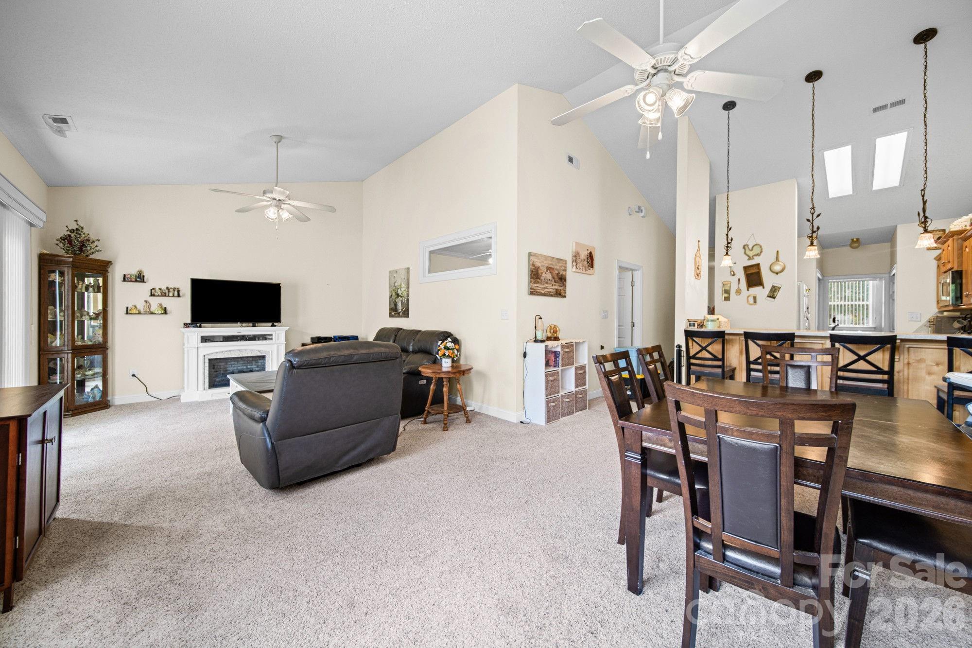 Enjoy easy, single-level living in The Terraces, a highly desirable 55+ community in Denver. Offering 2 bedrooms, 2 full baths, and 1,419 square feet, this all-brick townhome is one of the more spacious floor plans in the neighborhood and includes a versatile flex room that can serve as an office, hobby room, reading room, guest space, or whatever best fits your lifestyle.  The soaring vaulted ceilings, abundant natural light, and an open layout designed for both everyday comfort and entertaining. The spacious living and dining areas provide plenty of room for gatherings, while the bright kitchen features a breakfast bar, pantry storage, ample cabinetry, and all appliances convey, including the refrigerator, washer, and dryer.  Recent updates provide added peace of mind, including a new heat pump in 2024, vinyl plank flooring in the hallway and flex room in 2026, a new primary bath toilet, garbage disposal, ceiling fan, and rolling shade in the attached two-car carport. Outside, enjoy a peaceful rear setting with a quiet, unobstructed view. When it's time to get out and socialize, The Terraces offers a welcoming clubhouse with regular activities including bingo, card games, book club gatherings, pool tournaments, seasonal events, and more. Residents also enjoy walking trails and a scenic pond.

The HOA covers water, sewer, trash service and lawn care and community amenities, making it easy to spend less time on chores and more time enjoying life.

Conveniently located near Lake Norman, shopping, dining, medical facilities, and everyday essentials, this move-in ready home offers the comfort, convenience, and sense of community that make The Terraces such a special place to call home.