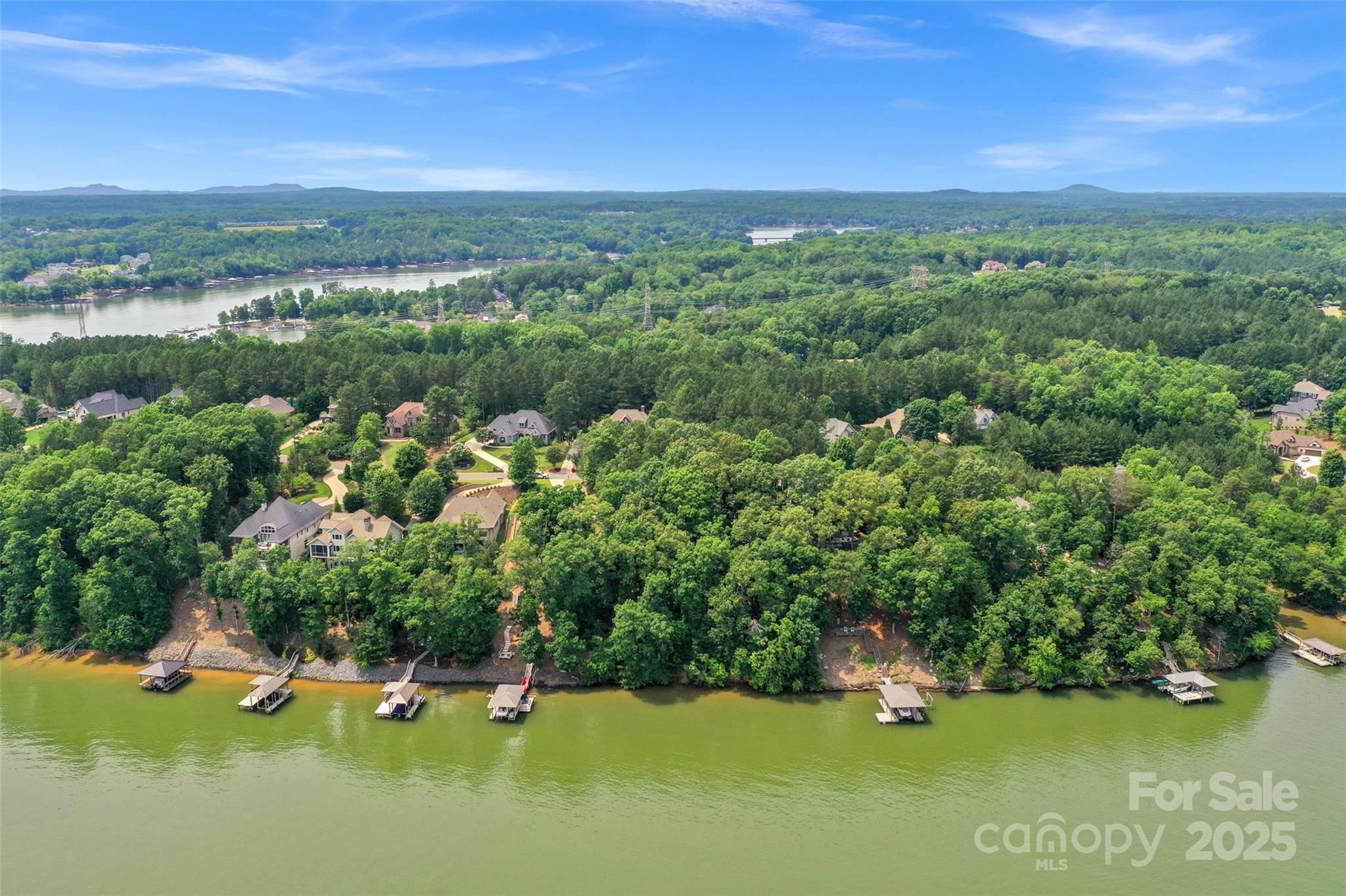 Experience unparalleled Lake Wylie waterfront living on this premier .47-acre dockable lot situated on the main body of the lake. Featuring expansive, permanent lake views that will never be obstructed, this rare homesite is perfectly suited for walkout basement construction. As one of the few remaining opportunities on Lake Pointe Drive, this property offers incredible flexibility with no initial build time requirements. Whether you choose from the community’s preferred builder list or bring your own qualified custom builder, you can design a residence that meets the minimum 2,000 HLA for a 1-story or 2,400 HLA for a two-story home.  The Reflection Pointe community provides a resort-style lifestyle with an extensive amenity package, including a clubhouse, swimming pool, tennis courts, and a waterfront pavilion with a community beach. Residents enjoy paved walking paths, a recreation field, fountained ponds, and a marina area. Ideally located for both relaxation and convenience, the lot is just 10 minutes from Downtown Belmont’s popular breweries and retail, 20 minutes from Charlotte Douglas International Airport, and only 30 minutes from Uptown Charlotte. This is a must-see for buyers seeking a dockable waterfront lot with wide-water views in a prime North Carolina location.