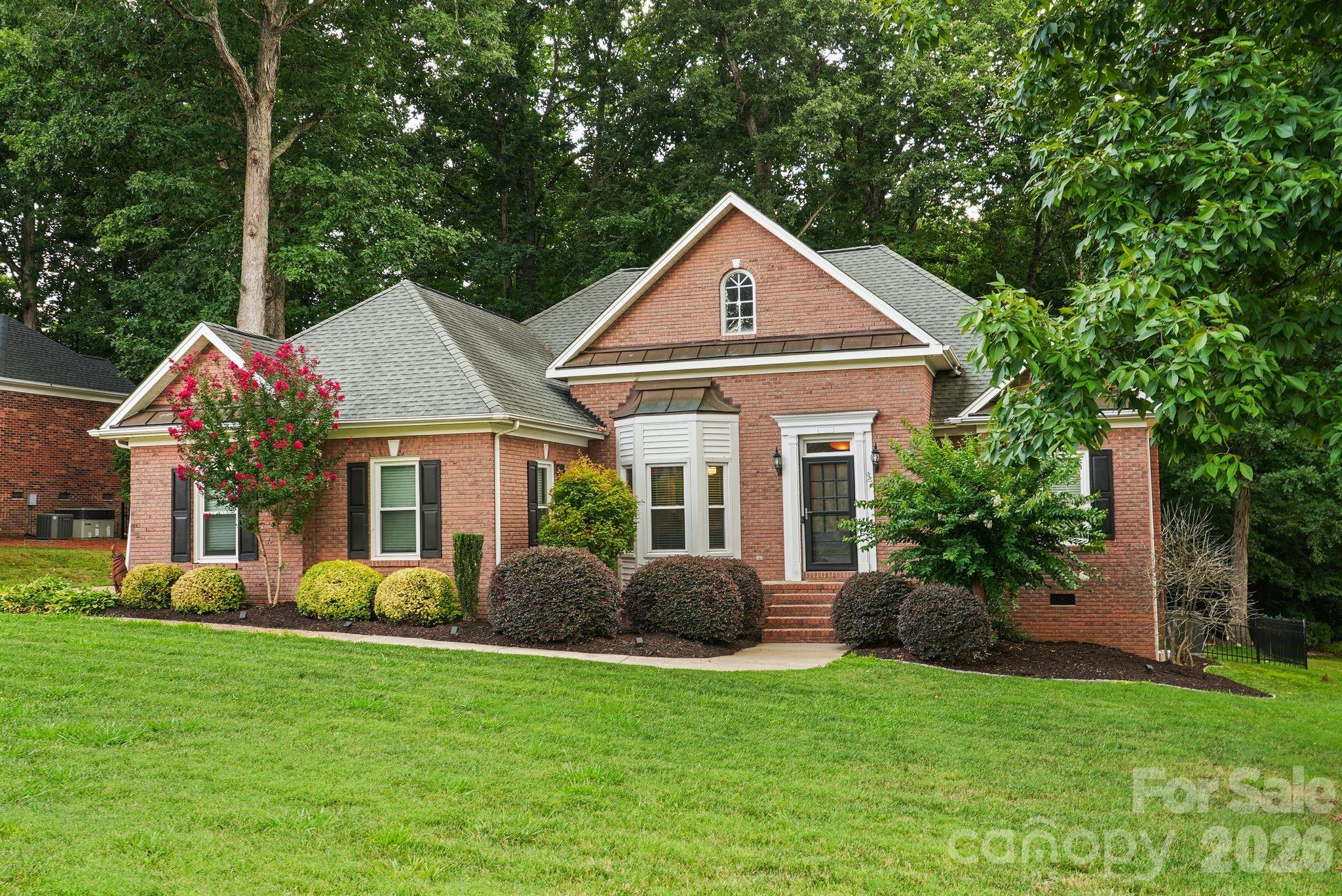 Move-in ready and set in one of Matthews' most amenity-rich communities, 4437 Shannamara Drive is a 4-bedroom, 2.5-bath brick home offering 2,319 square feet of heated living space on a large, wooded 0.35-acre lot. New carpet and fresh interior paint mean no punch list — just unpack and settle in. The main level holds the primary suite with its own full bath, two additional bedrooms sharing a second full bath, and a powder room for guests — everyday living without a single trip up the stairs. A private fourth bedroom claims the entire upper level, with attic storage nearby for seasonal items. A gas fireplace anchors the living room, the kitchen opens to a sunny breakfast nook, and a formal dining room stands ready for entertaining. Step outside to a large rear deck shaded by mature trees. The attached two-car garage adds 465 square feet of parking and storage, and the big-ticket systems are already handled: HVAC (2022), heat pump (2020), and gas water heater (2021). Shannamara residents enjoy a neighborhood pool, clubhouse, tennis courts, pickleball courts, and a playground, all within a five-minute walk of The Divide golf course. Minutes to I-485. Showings Begin Saturday