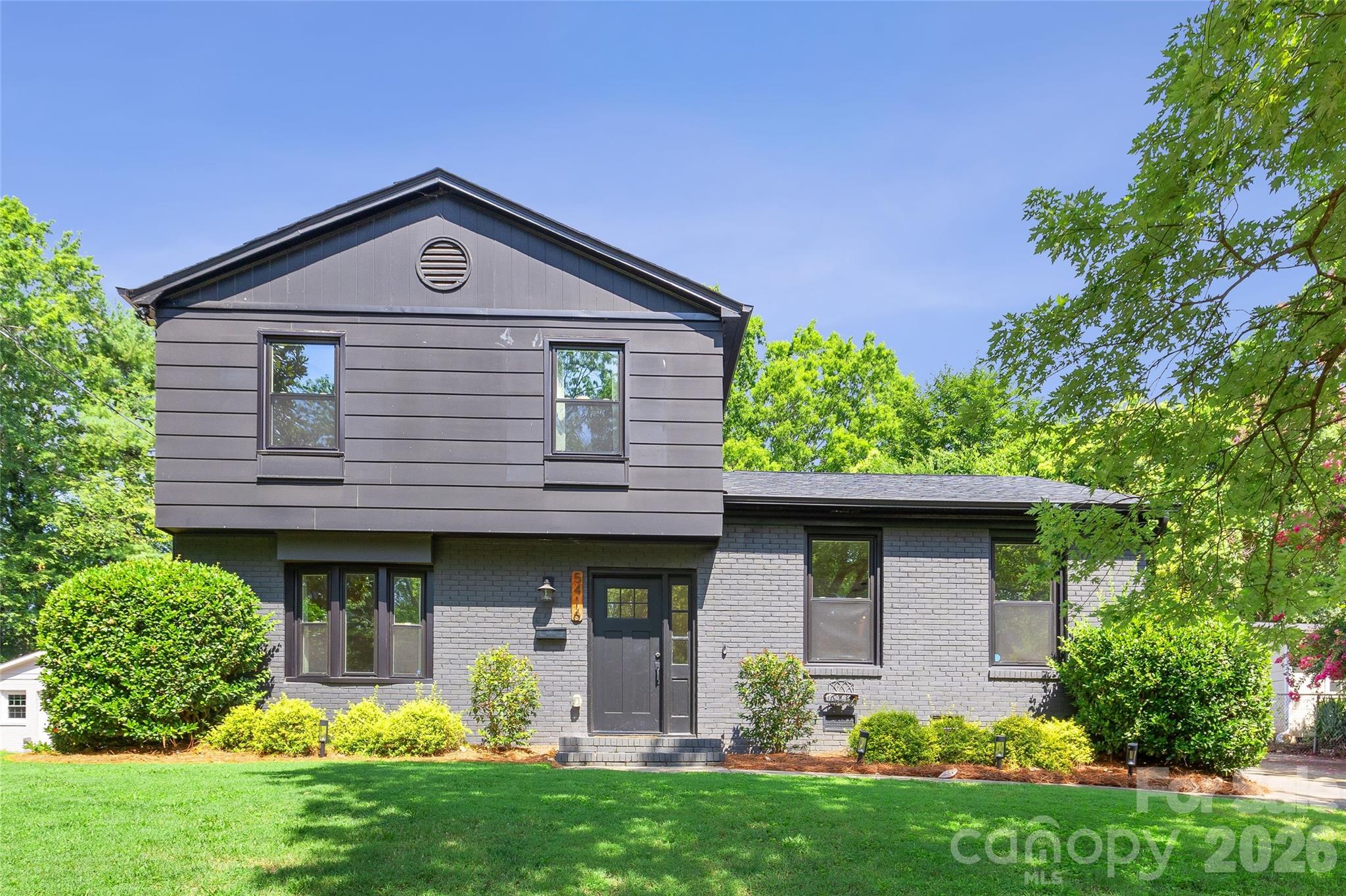 Welcome to this beautifully renovated home in the highly sought-after Madison Park neighborhood, where timeless charm meets modern style. Renovated just five years ago, this home offers peace of mind with major system updates including the roof, HVAC, ductwork, plumbing, and electrical in 2021.

The open-concept floor plan is centered around a stunning designer kitchen featuring a large quartz island with bar seating, quartz countertops, stainless steel appliances, smooth-top electric range with stainless vent hood, eye-catching herringbone tile backsplash, recessed lighting, and rich hardwood floors that flow throughout the main living areas. The kitchen opens seamlessly to the dining area, creating the perfect space for everyday living and entertaining.

The spacious lower-level living room is anchored by a cozy wood-burning fireplace and offers direct access to the backyard through a door leading to an expanded concrete patio. This level also features a laundry room and a generous storage closet. French doors off the kitchen open to a newer wood deck overlooking an exceptionally private backyard.

Outside, the owners have thoughtfully transformed the outdoor living space with professionally planned flowering shrubs, privacy trees, and a fully fenced backyard with wood privacy fencing—creating a beautiful setting for relaxing, entertaining, or enjoying quiet evenings outdoors.

Upstairs, you'll find three spacious bedrooms and two beautifully updated full baths. The guest bath features designer tile and a relaxing garden tub, while the luxurious primary suite offers a double vanity, elegant designer tile, and a large frameless glass shower.

Ideally located in one of Charlotte's most desirable neighborhoods, Madison Park offers convenient access to SouthPark, Park Road Shopping Center, the Light Rail, Uptown Charlotte, and countless restaurants, breweries, parks, and greenways. This move-in ready home combines quality updates, stylish finishes, and an unbeatable location.