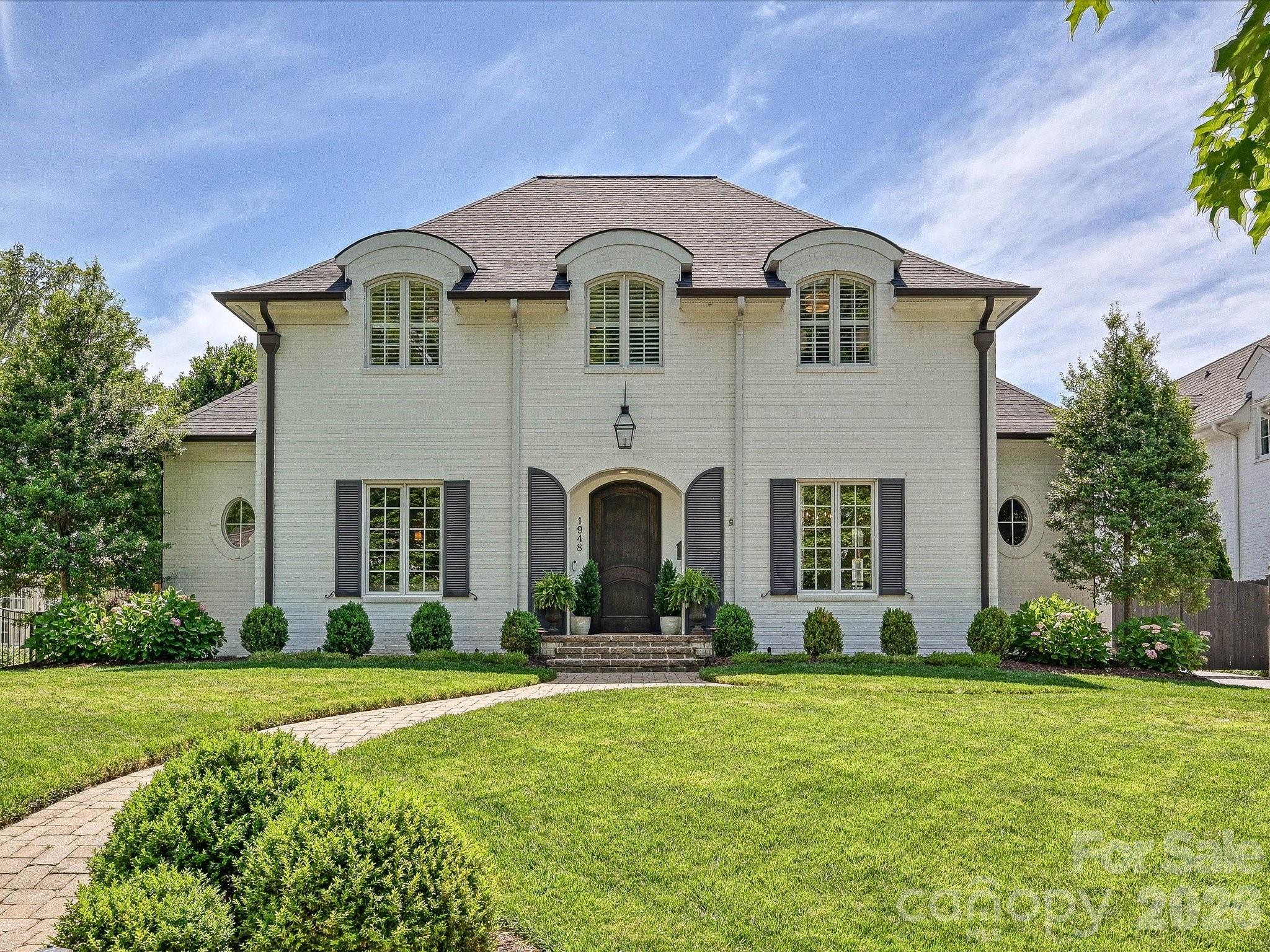Nestled on one of Myers Park’s most coveted streets, this sophisticated residence offers the perfect blend of walkable convenience and high-end design. Featuring 10-foot ceilings on the main level & 9-foot ceilings upstairs, the open floorplan seamlessly combines timeless grace with modern luxury. The heart of the home features an exquisite renovation designed by Emily Bourgeois and executed by Bourgeois McGinn Builders. The gourmet kitchen is a chef’s dream, anchored by a central island, quartzite countertops, and glazed tile. It flows into a refined family room defined by a striking custom barrel ceiling, designer fireplace, and artisan built-ins. The thoughtful layout includes a primary suite on the main level, while the second floor hosts three generous bedrooms and a versatile bonus room. Above the garage is a private secondary living quarters with a full bath —perfect for guests or a home office. Experience seamless indoor-outdoor living on the covered blue stone terrace, complete with built-in heaters and a custom brick fireplace. This retreat overlooks a private, lushly landscaped, and low-maintenance turfed backyard. Additional Features include Electric gated driveway, detached 2-car garage & irrigation. A true Charlotte stunner—luxury, location, and meticulous craftsmanship combined all within walking distance to the local shops & restaurants on Selwyn. Don’t miss this one!