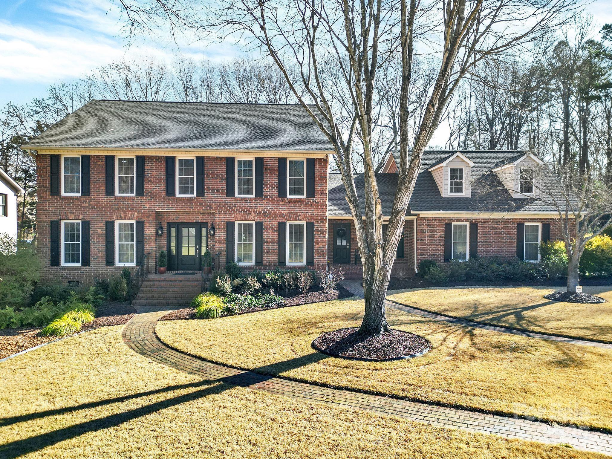 Multiple Offers- Offer deadline 5:00 PM, Sunday 1/11/26. Classic two-story brick home nestled on a half-acre lot in the well-established, mature neighborhood of Shiland Hills, offering over 4,000 square feet of beautifully maintained living space. This 4-bedroom, 3-bath home blends timeless character with thoughtful updates throughout and is conveniently located just minutes from shopping, dining, and easy interstate access. The main level features a guest suite, formal living room or office, dining room, and welcoming foyer—each accented by hardwood flooring. The spacious eat-in kitchen offers abundant cabinetry, a walk-in pantry, stainless appliances, double ovens, and an island cooktop. The impressive great room showcases a floor-to-ceiling fireplace, exposed wood beams, and built-in cabinetry—perfect for relaxing or entertaining. Upstairs, the expansive primary suite includes his-and-hers walk-in closets, a versatile flex room ideal for a nursery, office, or additional storage, and a fully remodeled primary bathroom (2022). Two additional bedrooms with walk-in closets share a full bath, while a 700-square-foot bonus room provides endless possibilities for recreation, media, or work-from-home space. Outdoor living is enhanced by a private fenced backyard, large screened tile porch, and paver patio—ideal for entertaining. Notable updates include new windows (2020), new roof (2022), detached garage roof (2019), refinished existing hardwood floors with new hardwoods added in the primary bedroom and hallway (2025), new exterior doors (2025), extensive crawl space improvements (2020) including a vapor barrier, drainage system, humidifier, and sump pump, split AC unit added to the detached garage (2022), and LeafFilter gutter protection (2024) Additional enhancements include shed with electricity, front and rear irrigation, polycarbonate flooring in both garages, and ring camera security system.