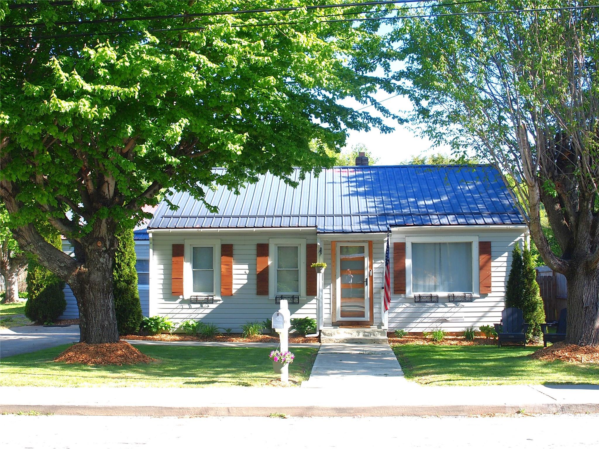 HUGE PRICE REDUCTION!! MOTIVATED SELLER!!  INVESTOR ALERT!  BRING OFFER!  Nestled in the heart of Waynesville’s charming, walkable, Hazelwood area, this partially remodeled 1,342-square-foot home offers the perfect blend of small-town nostalgia and modern convenience. You are just a short stroll away from local favorites like Smoky Mountain Roasters, quaint boutiques, and popular neighborhood restaurants. Designed for a low-maintenance lifestyle, the exterior features a durable metal roof and vinyl siding, allowing you more time to enjoy the vibrant community right outside your front door.
The interior has been transformed with high-end finishes, including a sleek new kitchen outfitted with granite countertops and stainless steel appliances. Comfort and peace of mind are guaranteed thanks to a total electrical upgrade and a brand-new LG mini-split HVAC system. The layout includes three updated bedrooms, highlighted by a primary suite with its own private ensuite bath and walk in closet. Outside, the nearly quarter-acre backyard is a private oasis, fully enclosed by an 8-foot wooden privacy fence. With a 10-foot gate providing easy RV parking, and a pavilion, wired with 110V outlet and television, ready for outdoor entertaining, this property is as functional as it is inviting.