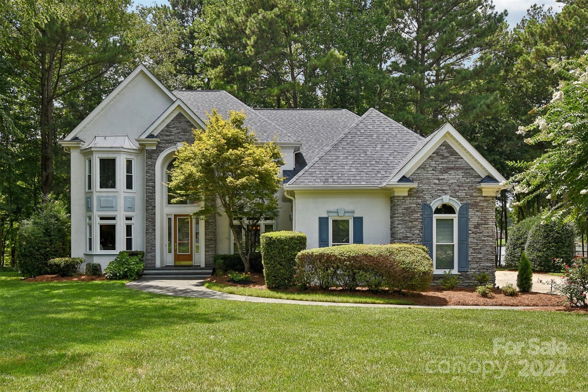 Custom built waterfront home in the Overlook community on a quiet cul-de-sac with stunning water views. It features a two-story entryway, open floor plan, a home office, formal dining room, and a primary bedroom with private terrace. The kitchen has granite countertops, a walk-in pantry, and a spacious island. The two-story family room offers natural light and scenic lake views. Enjoy all-season relaxation in the screened porch and low-maintenance composite wood deck, or escape to the charming sunroom with custom built-ins. The flat backyard serves as a wildlife sanctuary and leads to the personal boat dock. The boat dock has composite wood decking and a boat lift. The dock has deep water, which is perfect for swimming and relaxation; it also provides easy access to the main channel. There is plenty of storage in the large 3-car garage. The resort-style community offers amenities like pickleball/tennis courts, a pool, a boat ramp, playgrounds, and a clubhouse close to this property.