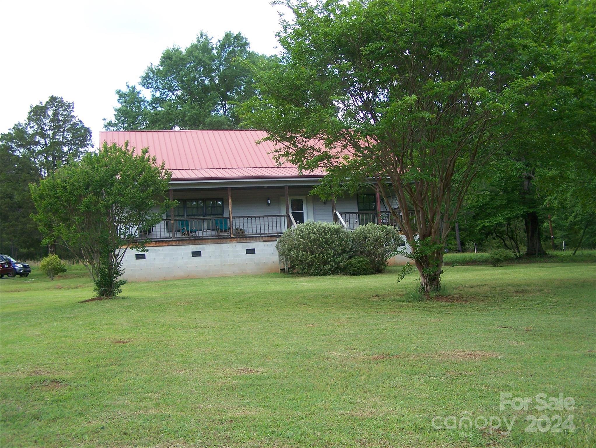 Country living at it’s best.  A 3 bedroom 2 1/2 bath home with 29.6 wooded acres with a barn/garage and workshop could be the perfect new place to call home.  New kitchen appliances, with dining area, open concept great room, and dining room.  The primary bedroom and bath are located on the main floor.  Laundry room is also on the main floor.  The front porch spans the entire front of the home, with two screened in porches.  The property is zoned for horses as well. The barn features two garage doors for storage of your cars, and tractors.  There is a workshop as well.