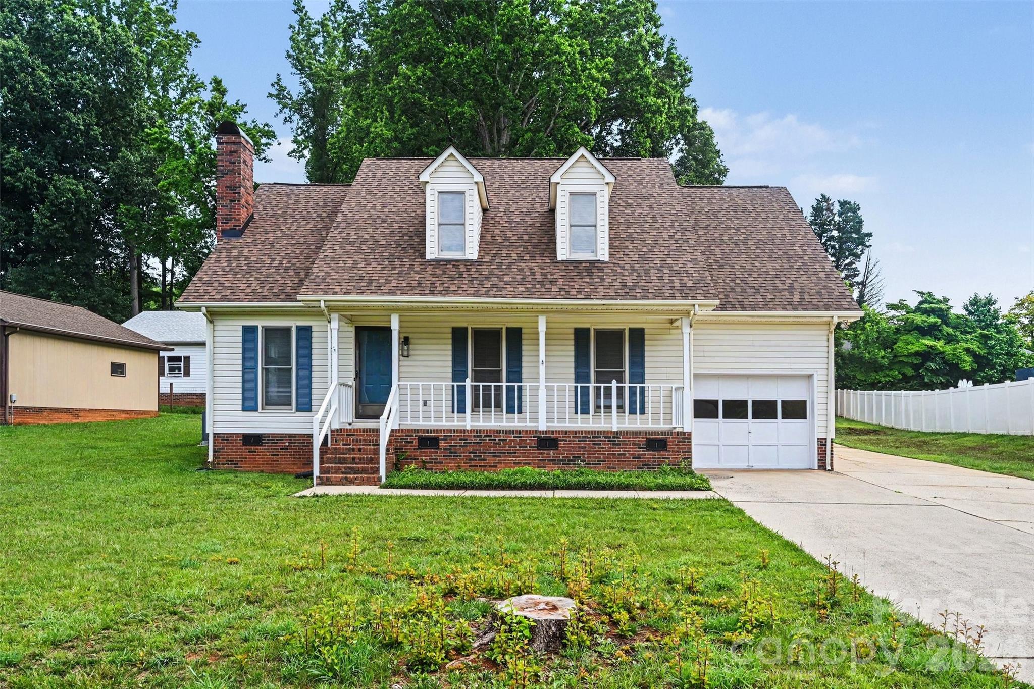 This charming Cape Cod style home is updated, upgraded and ready for you! A must see with 5 bedrooms and 3 full bathrooms. It has been thoughtfully remodeled with quality craftsmanship and stylish, modern finishes throughout.  The bright kitchen boasts new SS appliances, granite countertops, tile backsplash and pantry. Unwind in the comfortable living room, where high vaulted ceilings and accent wall meet the rustic charm of a traditional wood-burning fireplace. The main level primary suite is a spa- like retreat right at home! All 3 bathrooms are like new with custom tile showers. Storage won't be an issue with the attached and detached garages and shed. New roof in 2025 and a rocking chair front porch. A great location in a quiet neighborhood and NO HOA! Blocks from Downtown China Grove! Schedule a showing today!
