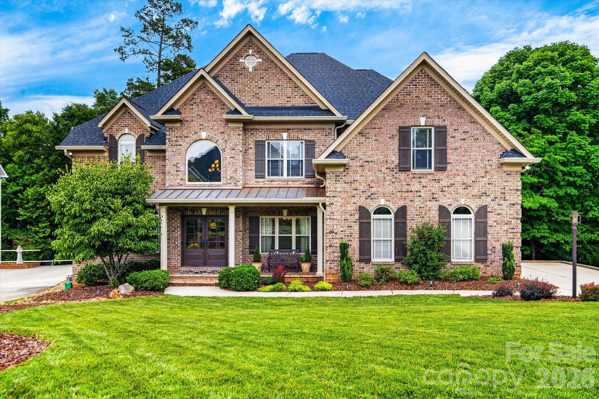 Welcome to this custom-built Iron River home in the highly sought-after Providence Plantation neighborhood. This 6-bedroom, 5 full and 2 half bath residence offers 5,700 square feet of thoughtfully designed living space, blending traditional architecture with modern style.
     Wine enthusiasts will love the 600-bottle, climate-controlled wine cellar, while the kitchen features a six-burner Dacor gas range and double ovens.  Step outside to the shaded, afternoon screened porch overlooking the private, wooded backyard and a charming playhouse - a true retreat for relaxing or entertaining.
     The primary suite impresses with an oversized walk-in closet and a spa-like en suite bath featuring a travertine tile surround, soaring ceilings, frameless glass, multiple shower heads, and a garden tub.  On the main level, the family room opens to the kitchen, complimented by dual staircases, designer tile, wood window blinds, whole-house audio, and hardwood floors.
     The finished basement offers a billiards area in front of a stone fireplace, a media room with surround sound, and a classic wet bar with refrigerator.  Storage abounds, with unfinished basement space, garage shelving, and multiple walk-in closets throughout.  Recent updates offer peace of mind: new roof and gutters (2025), all three A/C units replaced since 2022, and new carpet upstairs (2025).
     Set in an award-winning school zone with easy beltway access, this home offers the perfect balance of wooded privacy and everyday convenience.  Don't miss this exceptional opportunity in Providence Plantation.