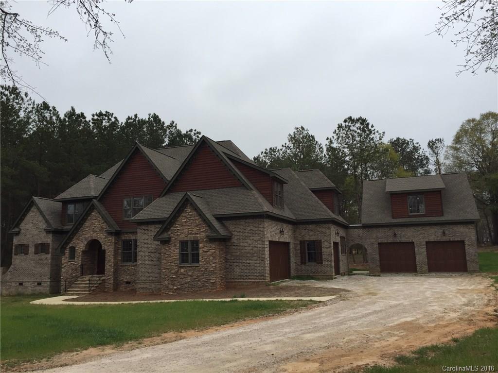 STUNNING home in equestrian community. Open floor plan w/ oversized kitchen w/ large bar w/ seating. Master bedroom on the main level with 5 additional bedrooms on upper level. All hardwood floors on main level and upper level w/ exception of carpet going in upper bedrooms. Large media room with fireplace and wet bar on upper level. Beautiful covered porch on the back of the home overlooking heavily wooded backyard. Many rooms of the home have great views of the community barn and pastures.