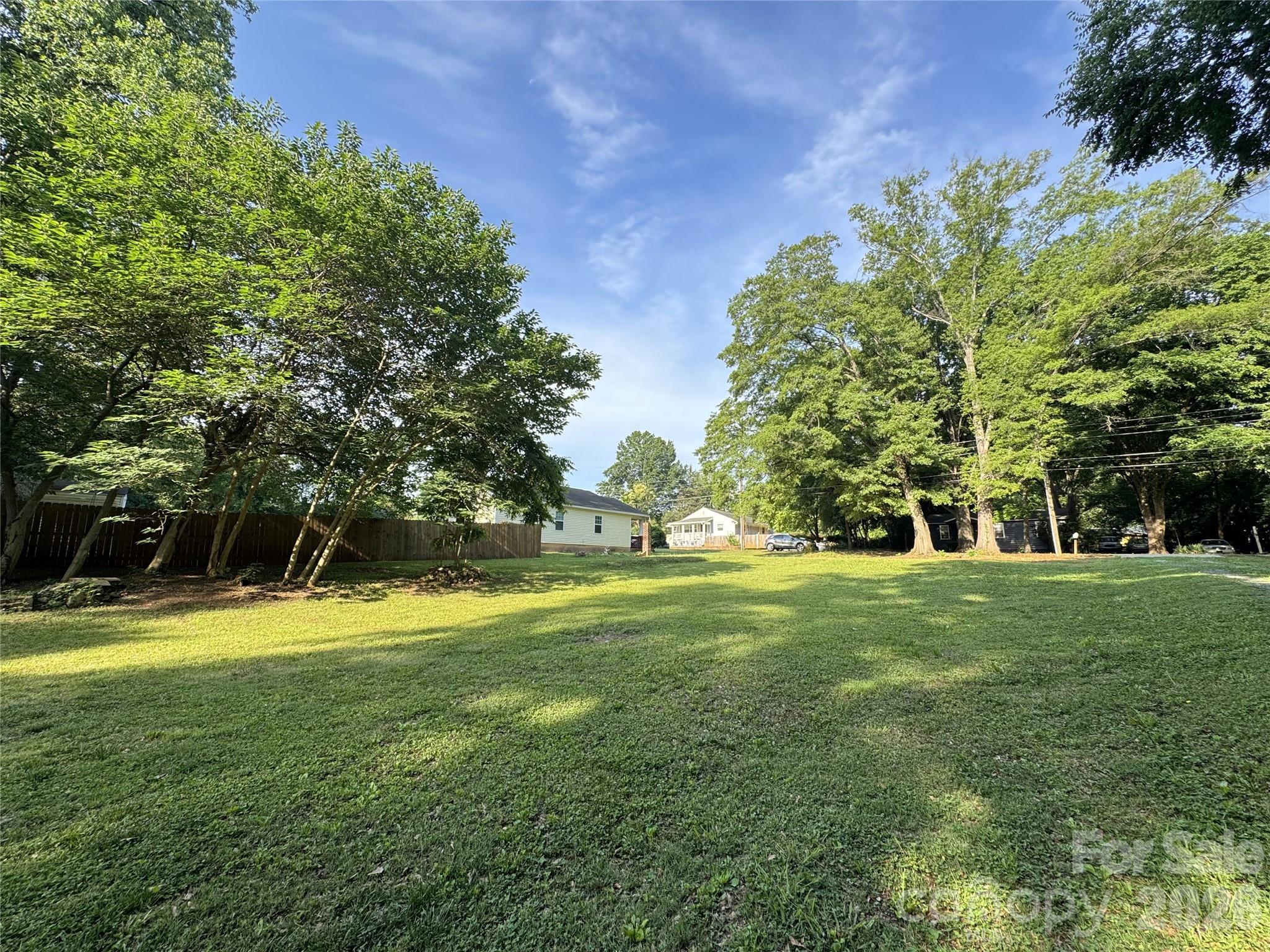 BUILDER AND INVESTOR OPPORTUNITY in a rapidly growing Charlotte location and NO HOA. Conveniently situated minutes from Uptown Charlotte, South End, Charlotte Douglas Airport, major highways including I-77, shopping, dining, entertainment, and more. Surrounded by ongoing development and new construction, this property presents excellent potential for builders, developers, and investors alike. Nearby new construction townhomes are selling in the $380s per townhome, creating strong development potential. City water and city sewer access available. Strategically positioned to provide both accessibility and a more private setting while remaining close to everything Charlotte has to offer.