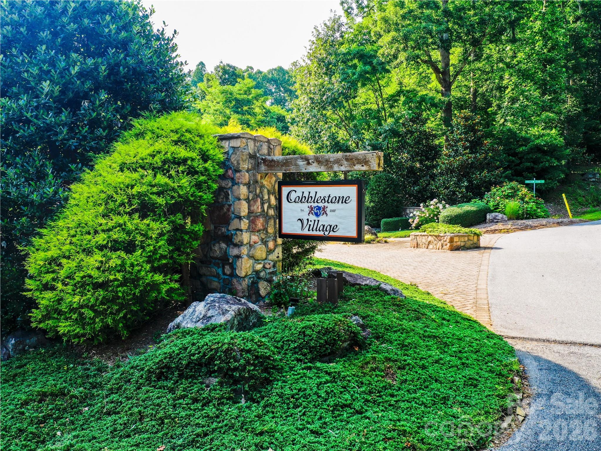Cobblestone Village is a neighborhood of elegant, well-maintained homes near Flat Rock, Carl Sandburg Home, Flat Rock Playhouse, downtown Hendersonville, and I-26 for an easy SC commute. This private lot features 225' of road frontage, gently slopes up to Falkirk Way, and has a peaceful creek on the left. Enjoy quiet surroundings and local wildlife. Bring your vision and build your dream home!