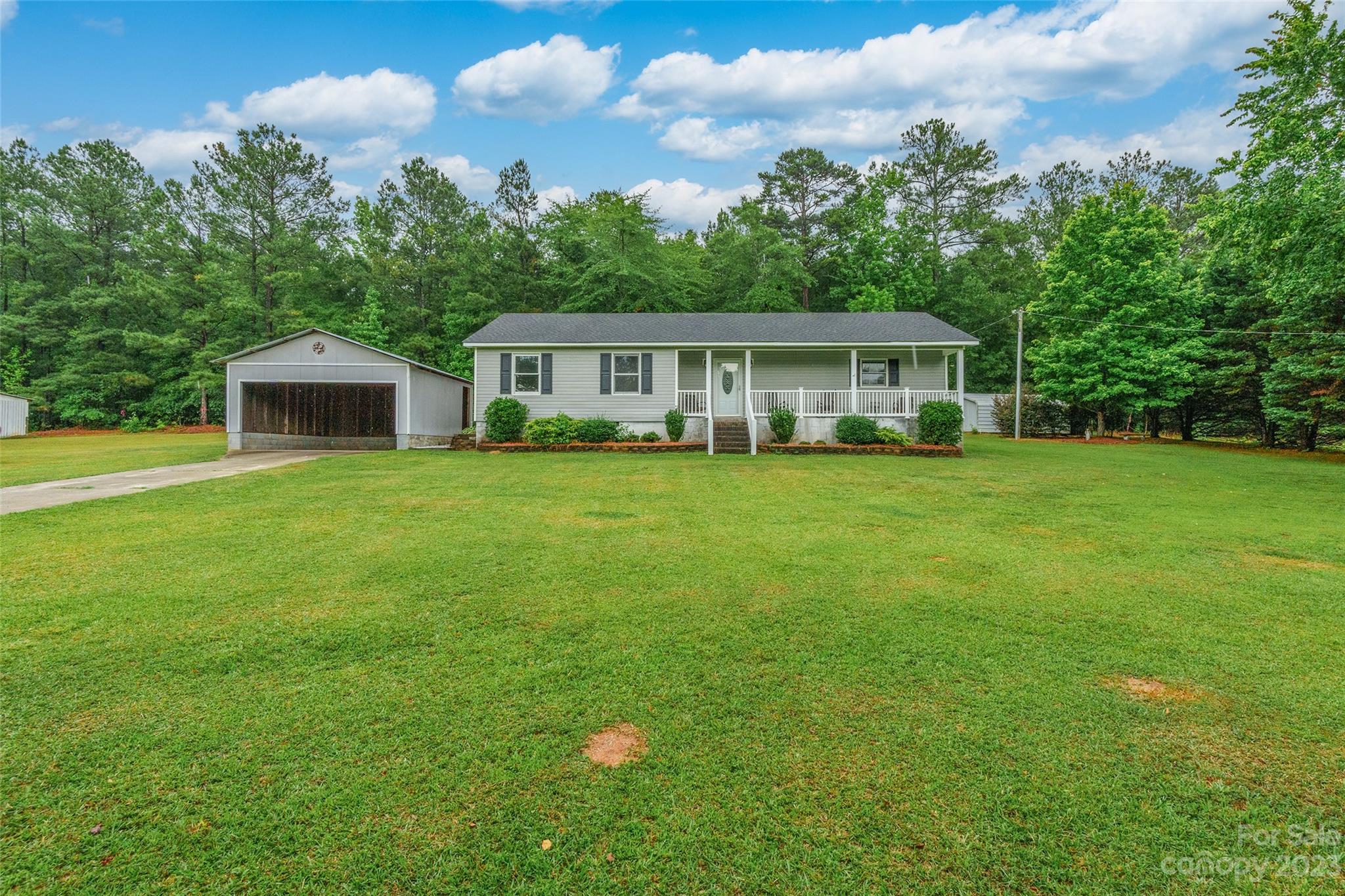 This adorable 3 bedroom, 2 bathroom ranch offers all the privacy and convenience of country living! Situated on over 2 acres of private land in Jefferson, this home has bright and open rooms, a sunroom, and covered parking. A separate cabin in the back yard has a rocking chair front porch and endless potential uses. There is a covered grill shed, detatched metal shop, and a 4 stall barn with a feed room and wash bay. Plenty of outdoor storage and made private from the road by an established tree line.