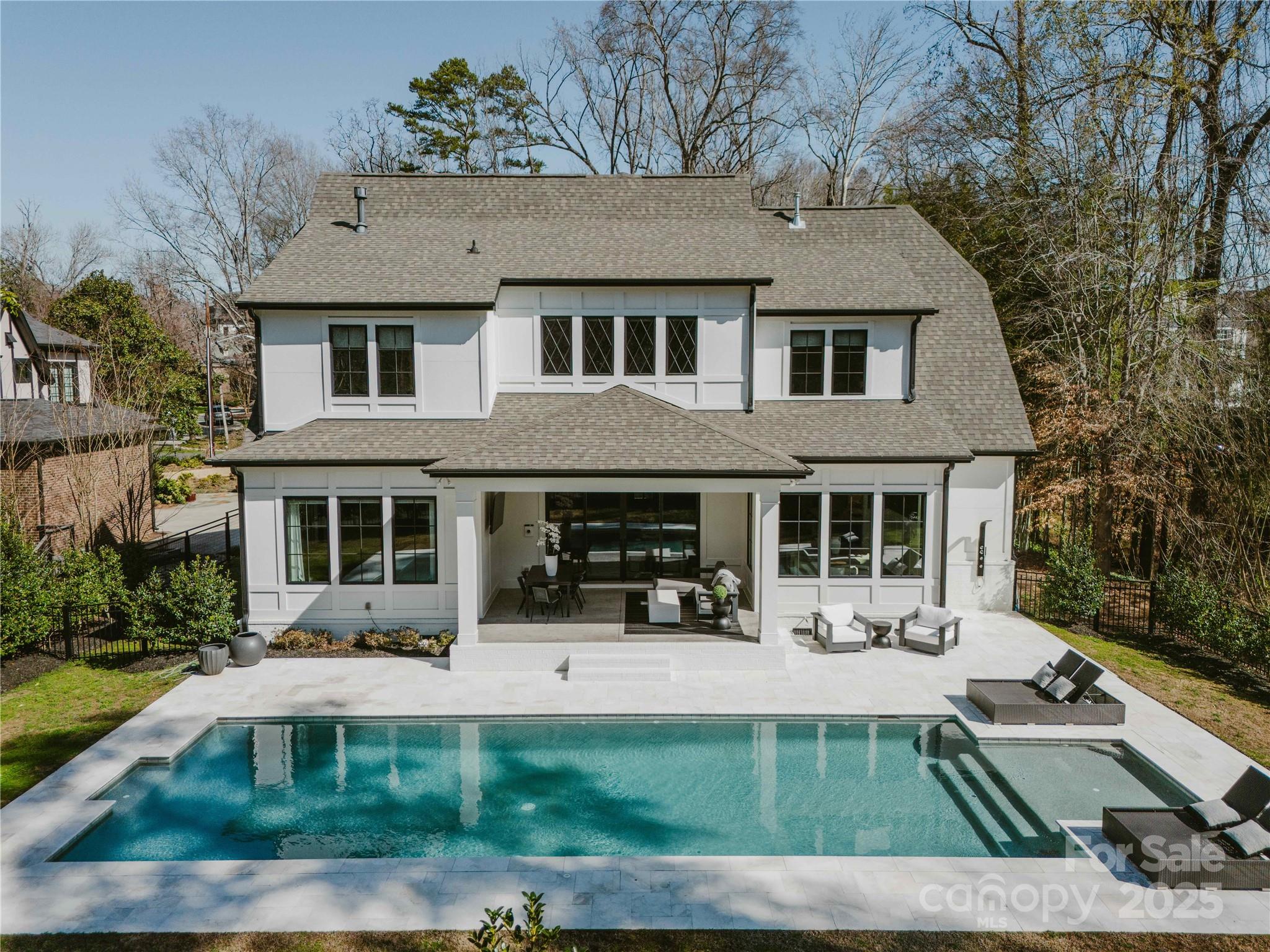 Some homes turn heads—this one stops traffic. Built by Copper Builders in 2019, this 5-bedroom, 4.5-bath + bonus stunner is packed with luxury finishes and smart design. The great room welcomes you with a gas fireplace and built-ins, while the first-floor primary suite boasts dual walk-in closets. The gourmet kitchen is a showstopper with a 42” KitchenAid fridge, 48” JennAir dual-fuel range, quartz counters, soft-close cabinetry, and a walk-in pantry. Tech enthusiasts will love the Fosi surround sound in the kitchen and the media room equipped with immersive audio. Outside, unwind in the oversized saltwater pool (2021) by Anthony Sylvan Pools, enjoy the stamped concrete porch, and relax in the flat, fenced backyard with irrigation. A 240V outlet in the 749 sq ft garage powers Level 2 EV charging, and a natural gas line is ready for your grill in the backyard. With Hunter Douglas treatments and Andersen windows, this home delivers the perfect blend of style, function, and innovation.