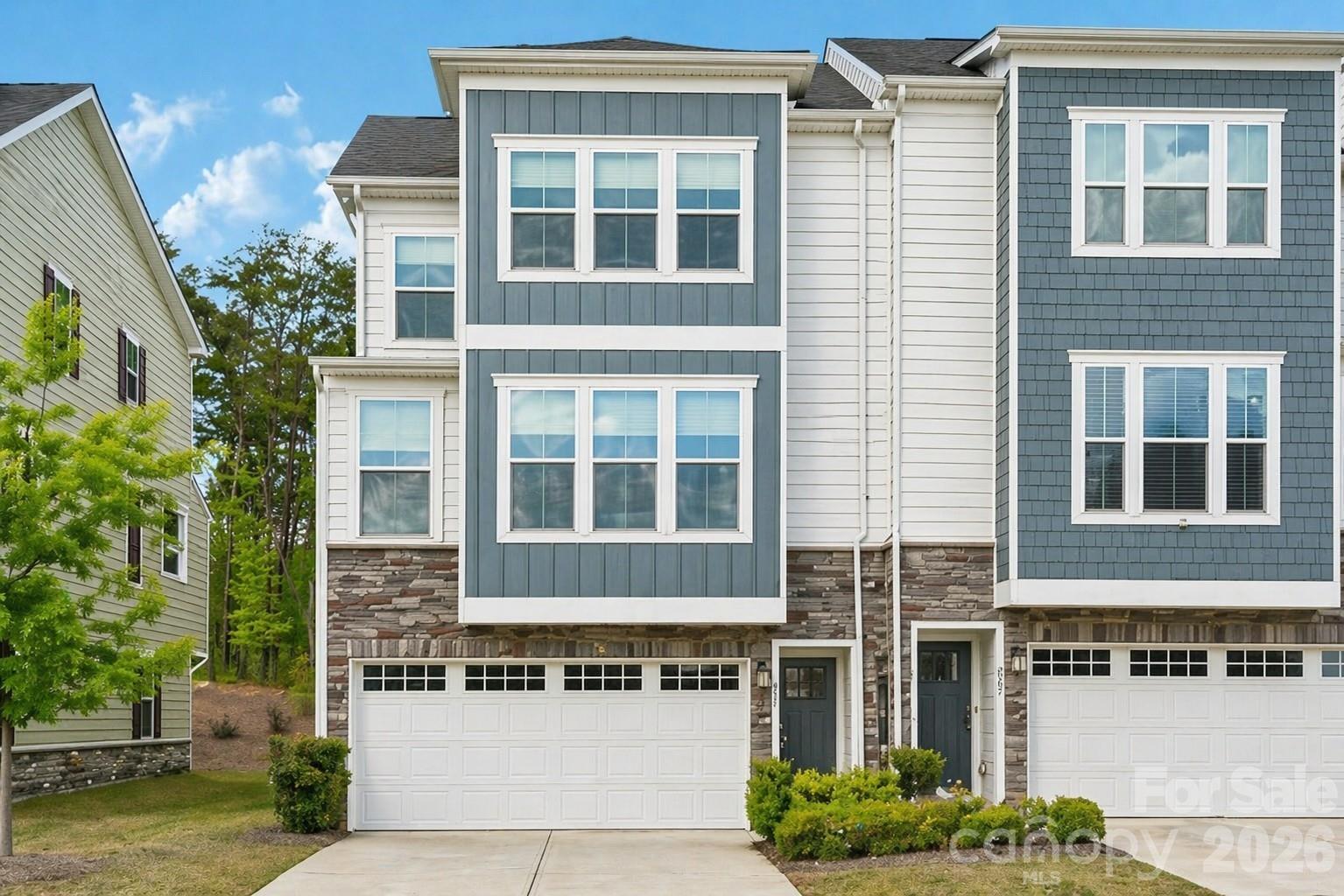 Relisted at a NEW price—an incredible VALUE for this Move-in-Ready, End-unit townhome! Meticulously maintained by its original and only owner, this beautiful three-story townhome offers extra windows, abundant natural light, and added privacy in a desirable walkable community just minutes from Lake Wylie & Fort Mill.  The first floor features a private guest suite with a full bath and separate rear entrance—ideal for overnight visitors, a home office, or flexible living space.  The open and inviting main level is designed for both everyday living and entertaining. The standout chef's kitchen features a large center island, gas cooktop, two (2) ovens, soft-close cabinetry, modern finishes, tall ceilings, smart thermostats and LED lighting.  Step outside onto the covered balcony overlooking a peaceful, tree-lined backdrop—an ideal place to relax, unwind, and entertain.  The upper level includes three spacious bedrooms. The primary suite features a private bath and walk-in closet, while the generously sized secondary bedrooms share a full hall bath. The conveniently located laundry area is also upstairs. The refrigerator, washer, and dryer are included, making this home truly move-in ready!  HOA includes exterior insurance and lawn maintenance.  The location is equally impressive. Enjoy convenient access to nearby shopping centers, parks, walking trails, golf, lake activities, recreation, restaurants, wine shops, a local brewery, and charming shops. Interstate 77 is easily accessible for commuting to Charlotte and exploring the surrounding area.  The upcoming Grove at Tega Cay will bring even more dining, entertainment, and convenience nearby.  With neighborhood rentals permitted, this property may also appeal to investors seeking a gorgeous townhome in a desirable and convenient location!