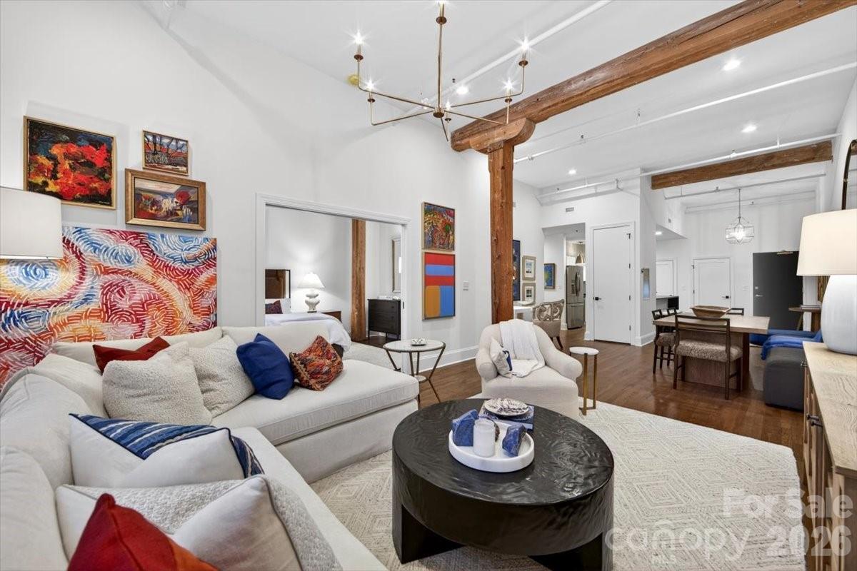 The finest home in South End! Chic, Historic, and Exceptionally Rare — A True South End Gem! Welcome to an extraordinary, designer-renovated residence in Factory Lofts, one of Charlotte’s most iconic and coveted buildings—formerly the historic Lance Cracker Factory and now home to just 50 exclusive residences. Set in the heart of South End, Charlotte’s hottest and most dynamic neighborhood, this home blends industrial heritage with refined, designer-level sophistication. This true one-bedroom home was gut-renovated by an internationally known interior designer as her personal residence, resulting in a level of craftsmanship and finish rarely seen in the market. Soaring 15' ceilings, refinished hardwood floors, a stunning leathered quartz waterfall island in the kitchen, and a spa-like bathroom set a timeless, elevated tone throughout. Thoughtfully designed custom closets maximize storage, while curated lighting by Visual Comfort adds warmth and architectural drama. The loft-like layout offers exceptional versatility—perfect as a primary residence, pied-à-terre, or income-producing investment. Even more rare, Factory Lofts is one of Charlotte’s only true LIVE/WORK buildings, allowing you to operate a boutique business, studio, or office directly from the unit. Additional highlights include gated parking, a SEPARATE STORAGE ROOM, and abundant original factory details that celebrate the building’s historic character. Stylish, flexible, and truly one of a kind—this is South End living at its finest.