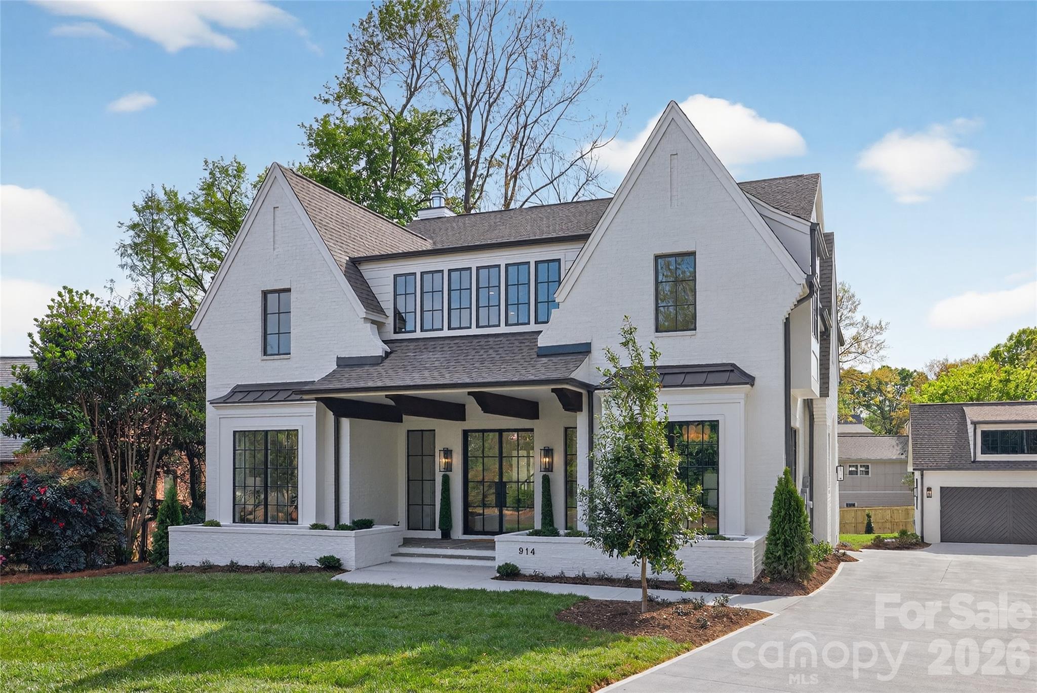 This newly completed residence makes an immediate impression with its white painted brick exterior, dramatic gables, and steel-style windows, creating a sophisticated yet timeless architectural presence. Built by Westwood Homes and developed by Gratia, the home reflects a thoughtful approach to design, craftsmanship, and livability.

Inside, beautifully curated finishes, designer lighting, and refined architectural details create an elegant and welcoming atmosphere throughout. The chef’s kitchen serves as the heart of the home, featuring commercial-grade Wolf appliances, custom cabinetry, and a generous island designed for gathering and entertaining. Open-concept living spaces are filled with natural light and flow seamlessly for both everyday living and hosting.

With over 4,500 heated square feet across three levels, the home offers a main-level guest suite, expansive living areas, upper-level loft and bonus spaces, and covered outdoor living with a fireplace, along with thoughtfully integrated architectural details throughout.

This is not typical new construction—it is a home designed with intention, character, and enduring style.