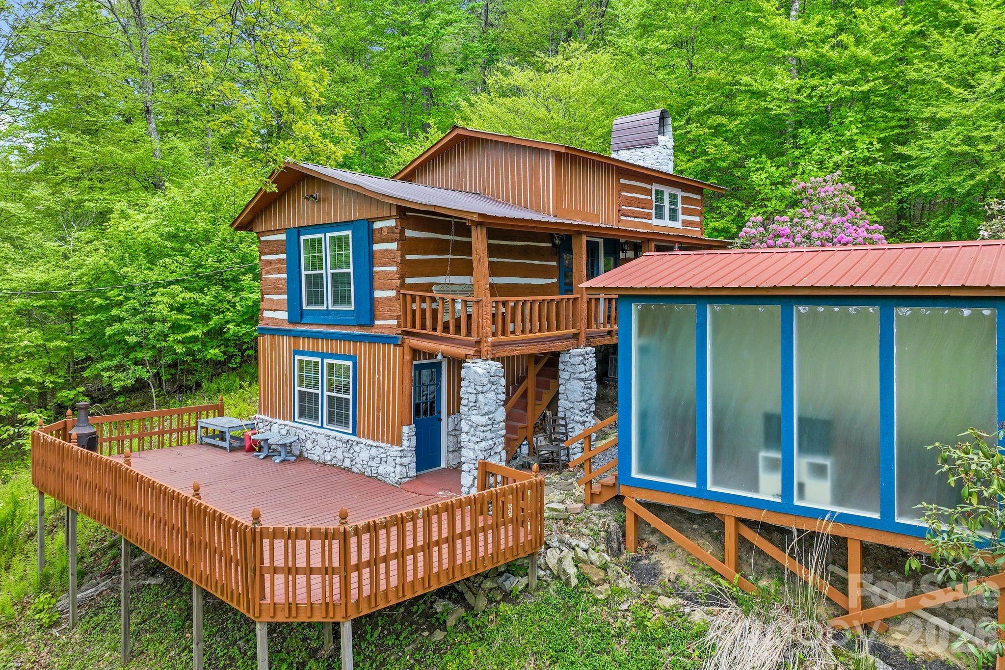A MOUNTAIN CABIN UNLIKE ANYTHING ELSE || At over 4,000 feet elevation in the Wolf Laurel Gated Community, nestled in the Blue Ridge Mountains of Western North Carolina, this cabin doesn't just impress — it surprises. What started as a rugged mountain retreat has been reimagined with a taste of Bavarian charm — reminiscent of cabins throughout the Bavarian Forest and the Czech Republic, where rustic character and modern luxury exist under the same roof. Seated on a wooded lot minutes from Hatley Pointe Ski Resort, the paved driveway sets the tone — this home is special. || WHERE RUSTIC MEETS REFINED || This property was selectively and thoughtfully updated. The wood walls and ceilings were re-stained and refinished. The exterior of the home and chimney were painted. Hardwood floors were recoated. The kitchen features upgraded appliances. The property now includes a sauna, washer, and dryer. A staircase was added to the kitchen. Mini-splits were installed for year-round comfort. || WHERE THE CABIN ENDS AND THE ART BEGINS || Lasvit Neverending Glory chandeliers anchor the interior — hand-blown Czech crystal sculptures modeled after the grand chandeliers of the world's most celebrated opera houses, from La Scala in Milan to the Metropolitan Opera in New York. These are not light fixtures in the ordinary sense. They are conversation pieces that happen to illuminate a room. The 208 sqft studio features Lasvit LiquidKristal panels — an architectural glass system developed by acclaimed British designer Ross Lovegrove, the same material used in landmark installations across the globe. The panels feel organic and alive with light. || THE SKI SLOPES AT YOUR DOOR || Hatley Pointe Ski Resort sits just minutes away — 54 acres of skiable terrain, 21 trails, night skiing, and a peak elevation of 4,700 feet. || Schedule your private showing today. 

In Wolf Laurel you can enjoy secure 24-hour gated access in this expansive 5,000+ acre community, near the Pisgah National Forest with direct Appalachian Trail connections. This location offers four-season weather. Wolf Laurel residents can enjoy a wealth of optional amenities through separate paid memberships like: 18-hole championship golf course at Wolf Laurel Country Club (highest east of the Mississippi), with clubhouse dining and pro shop. Heated swimming pool and tennis/pickleball courts. Fitness center with classes and wellness programs. Stocked trout fishing pond. Community pavilion, events, and more. This one needs to be seen in person.

No driveways. Prospective buyers must be accompanied by an agent to enter the gate to the community.

Certain updates to the property, including the studio, kitchen and exterior staircase, and shower, were completed without permits on file. Buyer is encouraged to conduct their own due diligence regarding permits and code compliance during the due diligence period.