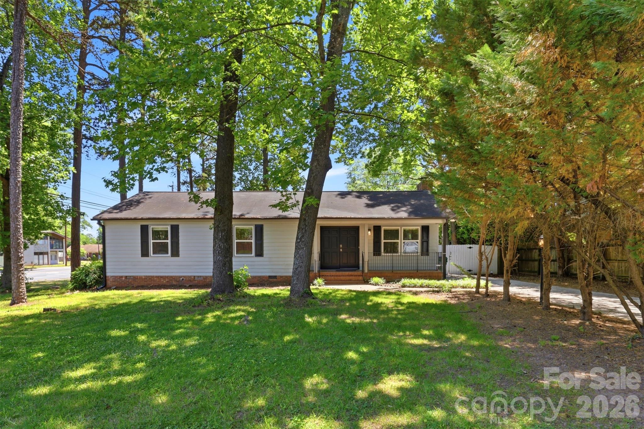 Located just 15 minutes of Uptown Charlotte, SouthPark, and downtown Matthews, this charming 3-bedroom, 2-bath home offers a blend of comfort, style, and everyday convenience in a highly desirable area. Fresh interior paint, abundant natural light, and a functional single-story layout create a bright and welcoming feel throughout the home. The cozy living room features a WOOD BURNING FIREPLACE and sliding glass doors that open to a spacious and FULLY FENCED BACKYARD, providing the perfect setting for relaxing, entertaining, pets, gardening, or outdoor dining. Mature surroundings and an established neighborhood add to the home’s character, while close proximity to shopping, dining, parks, and major commuter routes makes daily living easy and accessible.