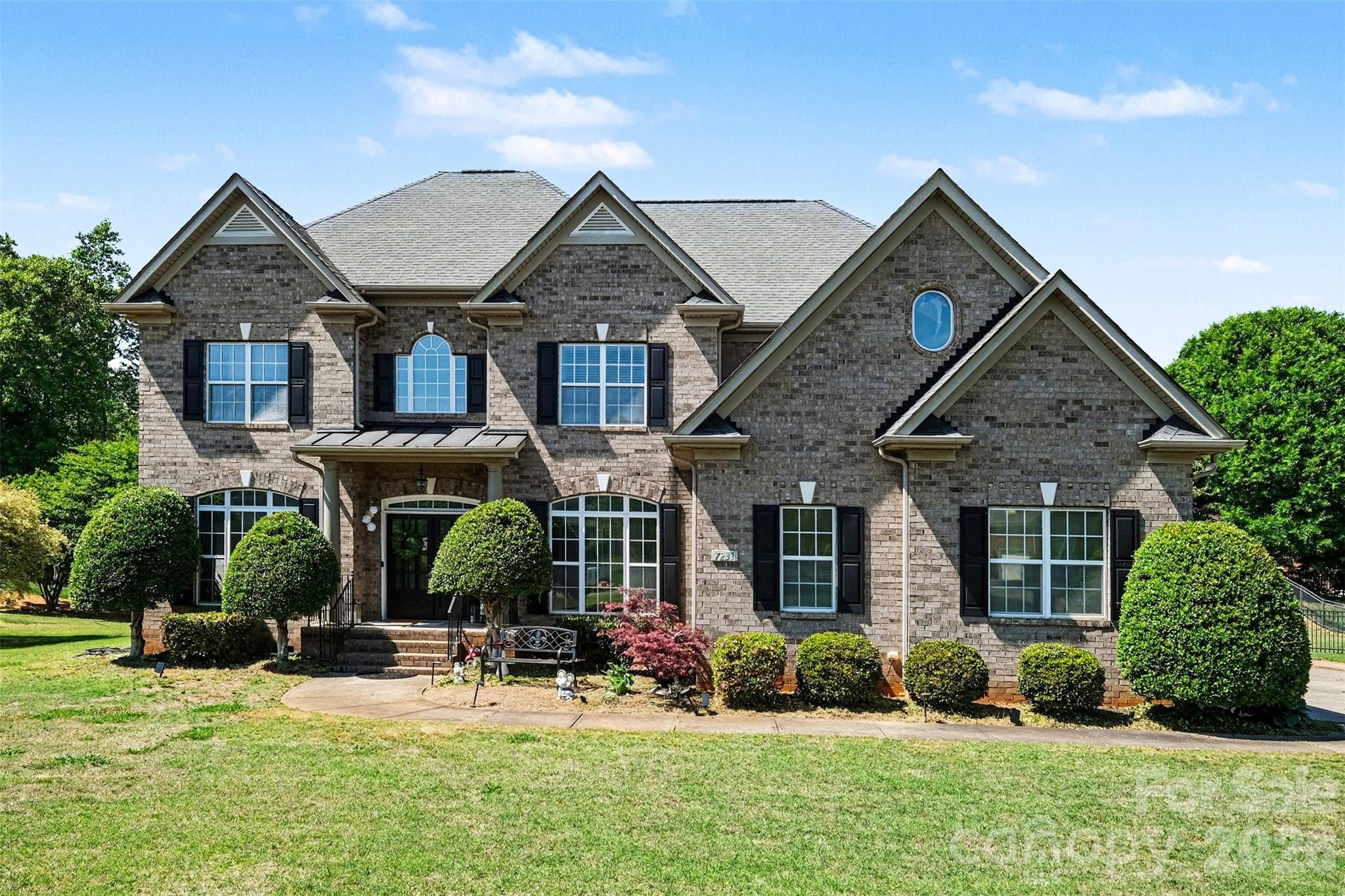 Welcome to this beautifully maintained home in the sought-after Ellington Farm community, where classic curb appeal and thoughtful updates come together on a spacious, landscaped lot. The stately brick exterior and inviting entry set the tone, leading into a bright interior filled with natural light, refined finishes, and a layout designed for both everyday comfort and effortless entertaining.

Inside, the main level offers an open yet defined flow with stylish living spaces that feel warm and welcoming. A standout feature is the convenience of a full bedroom and bathroom on the main level, ideal for guests, multi-generational living, or a private home office setup. The living areas connect seamlessly to a beautifully updated kitchen that serves as the heart of the home, complete with modern design touches, an oversized island, and views into the main gathering spaces, making it perfect for hosting and daily life alike.

Upstairs, the primary suite provides a true retreat with a spa-inspired feel, complemented by additional generously sized bedrooms and updated baths that reflect a cohesive, elevated style throughout. The third level adds even more versatility with a spacious bonus area that can easily function as a media room, playroom, or additional living space to suit your needs.

Step outside to a covered rear porch overlooking a large, open backyard, offering a peaceful setting for relaxing evenings or entertaining guests. The outdoor space is both private and expansive, providing endless opportunities to enjoy the natural surroundings.

Located in Mint Hill, Ellington Farm is known for its quiet, established atmosphere while still being conveniently close to shopping, dining, and everyday conveniences. This home offers the perfect blend of space, flexibility, and location, making it an exceptional opportunity for comfortable and elevated living.