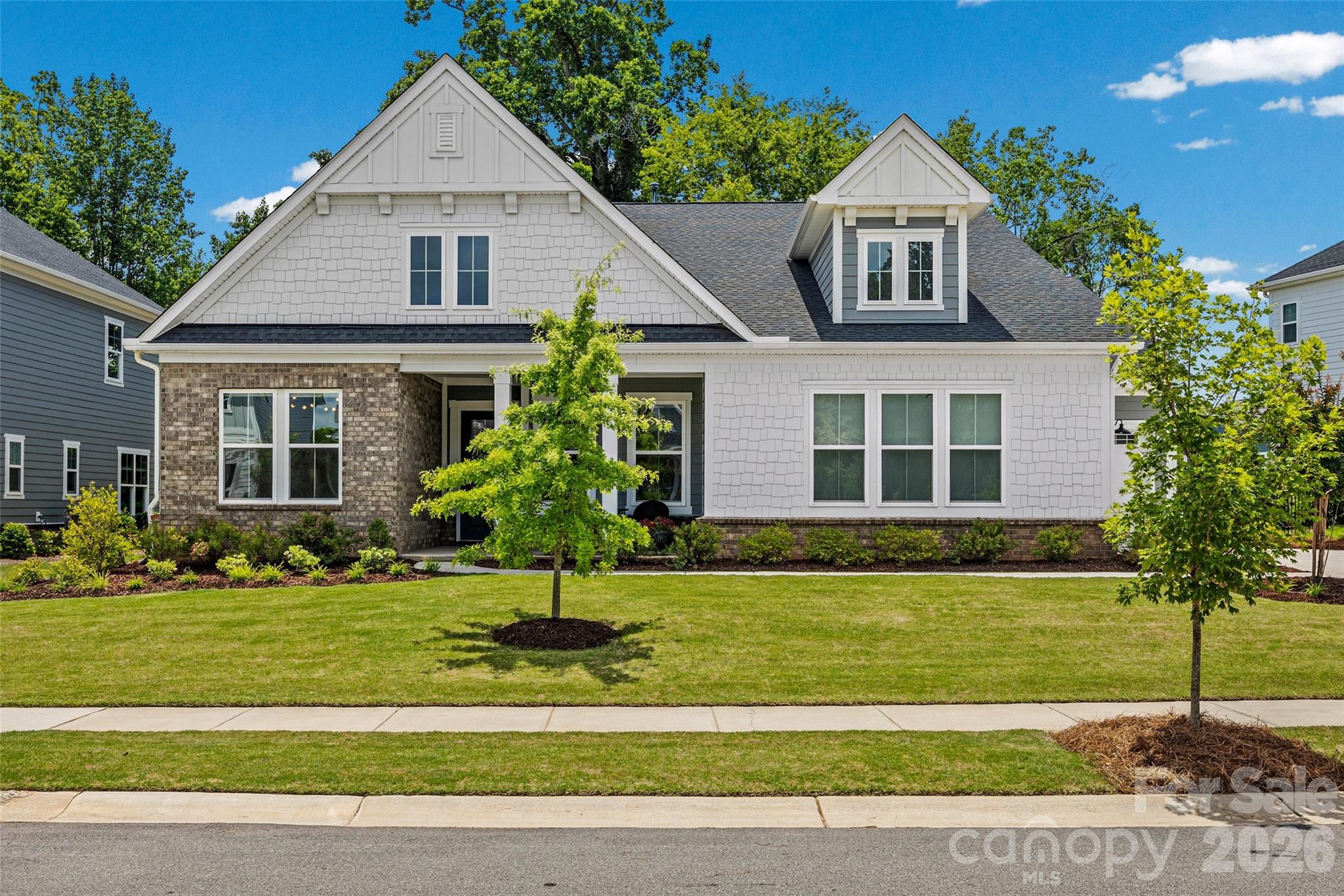 Nestled on a private, tree-lined lot in the desirable McLean South Shore community, this beautifully appointed one-level 4-bedroom, 3.5-bath home offers thoughtfully designed living spaces, quality finishes, and exceptional indoor-outdoor living. A spacious screened porch and fenced backyard create the perfect setting to relax, entertain, or simply enjoy the peaceful surroundings.
The open-concept floor plan welcomes you with 10-foot ceilings, abundant natural light, and a spacious great room anchored by a gas fireplace with custom built-ins and a striking tile surround. Oversized sliding glass doors seamlessly connect the great room to the screened porch, creating a wonderful extension of the living space and bringing the outdoors in.
Designed for both everyday living and entertaining, the kitchen features quartz countertops, a waterfall island, upgraded GE appliances, lighted upper cabinets, pull-out drawers, and abundant workspace. Adjacent to the kitchen, the bright breakfast area is currently enjoyed as a cozy sitting room—an inviting spot to savor your morning coffee while overlooking the backyard.
A dedicated home office with custom built-in cabinetry and a desk provides an ideal work-from-home space. Luxury vinyl plank flooring extends throughout the main living areas, complemented by ceramic tile in the bathrooms and laundry room, plush carpet in the bedrooms, custom lighting, and window treatments throughout.
The spacious primary suite offers a peaceful retreat with a freestanding soaking tub, oversized walk-in shower, and generous walk-in closet. The secondary bedrooms are all generously sized, including one with its own private en-suite bath, while the remaining bedrooms share a well-appointed hall bath with a dual vanity.
Additional features include a custom mudroom drop zone, laundry room cabinetry, smart home technology, and the remaining structural warranty for added peace of mind.
Located just minutes from Lake Wylie, McLean South Shore offers a lifestyle centered around nature and recreation with scenic walking trails, green spaces, and convenient access to boating, dining, and everyday conveniences. Enjoy the charm of historic Belmont with its locally owned restaurants, boutiques, and year-round events, while Uptown Charlotte is just 20–25 minutes away, offering an easy commute and endless entertainment.
