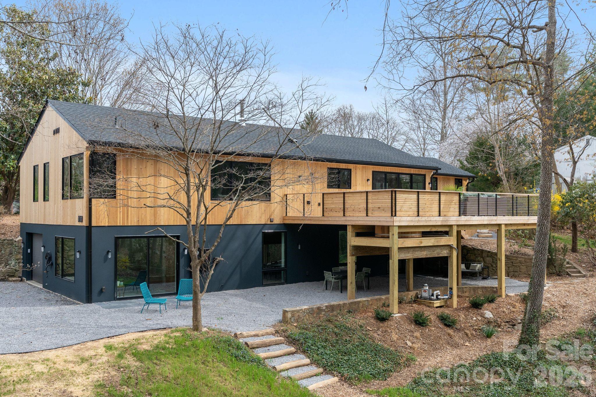 330 Windsor Road is a thoughtfully renovated GreenBuilt home that blends modern performance with timeless natural materials. Set on a beautiful half-acre lot in the desirable Lakeview Park, the home offers privacy, mature landscaping, and a sense of calm and peace of mind, while still being close to everything Asheville has to offer.

Inside, the home features solid white oak flooring, custom white oak cabinetry, vaulted western red cedar ceilings, and zero-VOC finishes throughout. The kitchen is both striking and functional, with “Absolute Black” counters and a Bedrosians penny tile backsplash, custom cabinetry, and high-end appliances. Natural light flows through the open living spaces, creating an inviting environment for everyday living and entertaining.

The home offers four bedrooms and four full bathrooms, including a beautiful main-level primary suite with a steam shower, soaking tub, and custom cabinetry finishes. A dedicated office features dramatic Sugi Ban (charred Japanese cypress) walls and ceiling cladding paired with preserved limestone flooring, creating a unique and inspiring workspace.

Outdoor living is equally special. A new cedar deck overlooks the private backyard, complete with a sunken cedar hot tub, raised edible garden beds, and thoughtfully designed landscaping featuring Japanese maples, magnolia, sourwood, and other mature trees. Practical features such as improved drainage, a waterproofed lower-level EV charger, a generator hookup, and energy-efficient systems add peace of mind and long-term performance.

With beautiful design, sustainable construction, and a rare combination of privacy and proximity to town, this updated North Asheville gem offers a truly distinctive living experience.