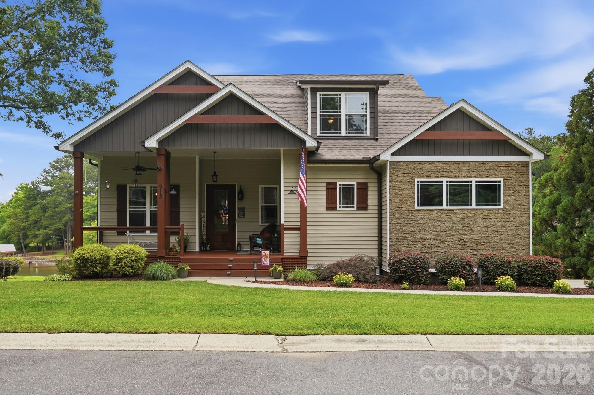Experience waterfront living at its finest in this stunning custom-built home, ideally situated just off the main channel with breathtaking panoramic lake views. From the moment you step into the welcoming foyer, you are greeted by an expansive open floor plan thoughtfully designed for both everyday living and entertaining. The sellers selected this highly desirable Don Gardner floor plan for its exceptional functionality and efficient use of space, creating the perfect lakefront retreat.

The home features a formal dining room, ideal for hosting special gatherings and holiday celebrations. The beautifully appointed kitchen includes a charming breakfast nook where you can enjoy serene lake views each morning. A large center island serves as the heart of the home, offering the perfect space to prepare meals while staying connected with family and guests in the spacious living room. The kitchen is equipped with quartz countertops, custom cabinetry, a natural gas stove with pot filler, drawer microwave, dishwasher, and refrigerator, all of which remain with the home. Quartz countertops continue throughout the residence, adding a touch of elegance and continuity.

The living room showcases soaring ceilings and a cozy gas-log fireplace, creating a warm and inviting atmosphere during cooler months. Step outside to the partially covered upper deck, which extends across the full rear of the home and provides exceptional outdoor living space with stunning waterfront views.

The main level includes a spacious 13x16 primary suite and a second bedroom, both overlooking the lake and offering direct access to the upper deck. The luxurious primary bath features a ceramic-tiled walk-in shower, double vanity with quartz countertops, two walk-in closets, and stylish floating linen shelves.

Upstairs, you will find two additional bedrooms connected by a Jack-and-Jill bathroom, along with a versatile bonus room perfect for recreation, a media room, or home office. A large walk-in attic provides abundant storage space.

The unfinished basement offers over 1,600 square feet of insulated space ready to be customized to suit your needs, whether as an in-law suite, guest quarters, or additional living area. The home also features a side-entry 24x24 two-car garage with durable epoxy flooring, along with additional paved parking outside.

The meticulously landscaped yard is maintained with an in-ground irrigation system, enhancing the home’s curb appeal. Completing this exceptional property is a deeded boat slip with a boat lift right out your back door,, making it easy to enjoy everything beautiful Lake Wylie has to offer. This home is located in the well sought after Lake Club Subdivision.

This remarkable waterfront home is ready for its new owners to begin making lifelong memories with family and friends.