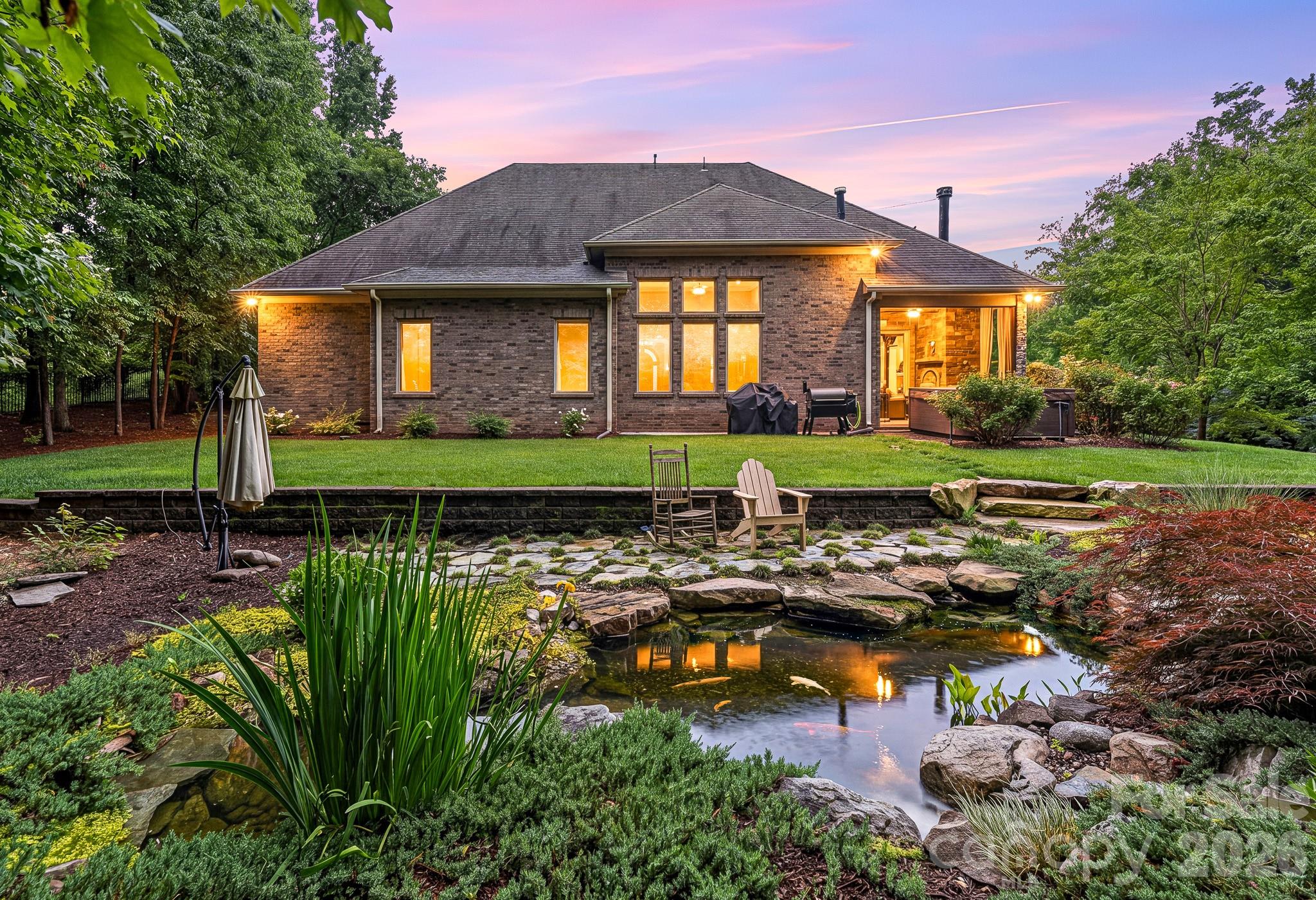 Weddington Schools and Low Union County Taxes...Experience the Pinnacle of Luxury in this Custom-built Masterpiece, perfectly situated within Weddington’s coveted Bromley community. This residence sits on a sprawling 1.21-acre private, wooded lot, featuring a stunning Hardscaped Koi Pond and a side-loading 3-car garage. Exquisite Design & Craftsmanship step inside to find Designer touches at every turn, from Artful lighting and Rich hardwood flooring to Soaring Coffered ceilings. The Grand Great room boasts a floor-to-ceiling fireplace and a breathtaking wall of windows that floods the home with natural light. A Chef’s Dream The Gourmet Kitchen is a showstopper, equipped with an Oversized Social Island and Handcrafted Cabinetry,Premium countertops and Professional-grade stainless appliances, a walk-in pantry and a butler’s pantry complete with a wine refrigerator—Perfect for Entertaining. Seamless Indoor-Outdoor LivingRetract the accordion doors to blend the interior with a Luxurious Covered Patio, featuring its own fireplace for year-round enjoyment of the Serene, Wooded backyard. Sophisticated Living Spaces Main Level Primary a true sanctuary with a Spa-inspired bath featuring a soaking tub, walk-in shower, double vanity, and a massive custom closet. Accommodations Two Large Secondary bedrooms with a Jack-and-Jill bath are located on the main floor, alongside a Private office and Formal Dining room. Second Level a massive Secondary living space with endless storage, an additional Owner's Suite with a Private study, and a Versatile Bonus room that can easily serve as a 5th bedroom. This home combines Architectural Elegance with a versatile floor plan, offering unparalleled Privacy in one of Weddington's most Prestigious Enclaves.