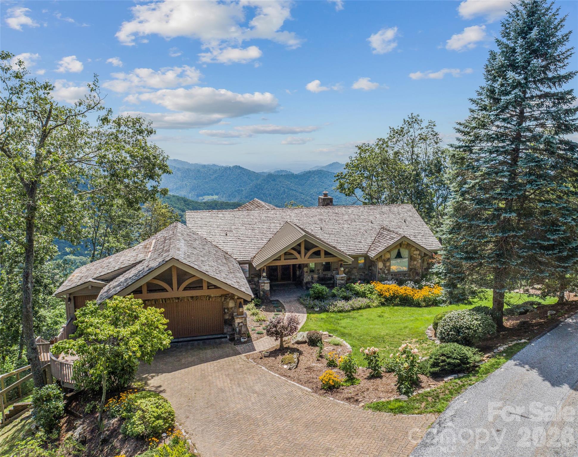 Not your typical post-and-beam! This is a mountain estate designed for elevated entertaining at 4,400’ on Slickrock Mountain in Mountain Air Country Club.

Crafted by Lindal Cedar Homes, the residence showcases premium engineered post-and-beam construction with rich cedar accents, expansive glass walls, and a design that prioritizes both structural integrity and architectural openness. Every space is oriented toward the sweeping southwest mountain and valley views, creating a constantly changing backdrop for gatherings large and small!

The dramatic great room sets the tone with vaulted ceilings, hardwood floors, stone fireplace, custom built-ins, and seamless flow into the dining area and chef’s kitchen. From here, living spaces extend naturally onto a generous entertaining deck—perfect for sunset dinners, cocktail hours around the fire, and cool Blue Ridge evenings spent outdoors.

The primary suite is a private retreat with its own stone fireplace, spacious en-suite bath, and screened-in deck for quiet mornings above the clouds. Guests are comfortably accommodated in well-separated lower-level bedroom suites, each offering privacy and mountain views!

Entertainment continues on the lower level with a spiral staircase leading to an equipped media room and rare indoor resistance pool—offering year-round wellness and recreation without leaving home!

The thoughtful site design enhances everyday livability, including a new roof, stone-paver driveway and walkway, fenced backyard, and gentle topography. Just minutes from the Clubhouse, Pro Shop, Fitness Center, Spa, and Village Green, the home blends privacy with immediate access to premier amenities.  Amenities accessible with club membership; see attachments for more details.

Residents of Mountain Air enjoy 24/7 gated security, six miles of hiking trails, seven parks, and private runway—along with quick access to Asheville, approximately 35 minutes away via four-lane roads. Our community is known for its mountaintop golf, panoramic Blue Ridge vistas, and the highest elevation runway east of the Mississippi. This one-of-a-kind home was designed not just for living—but for hosting, gathering, and remembering!