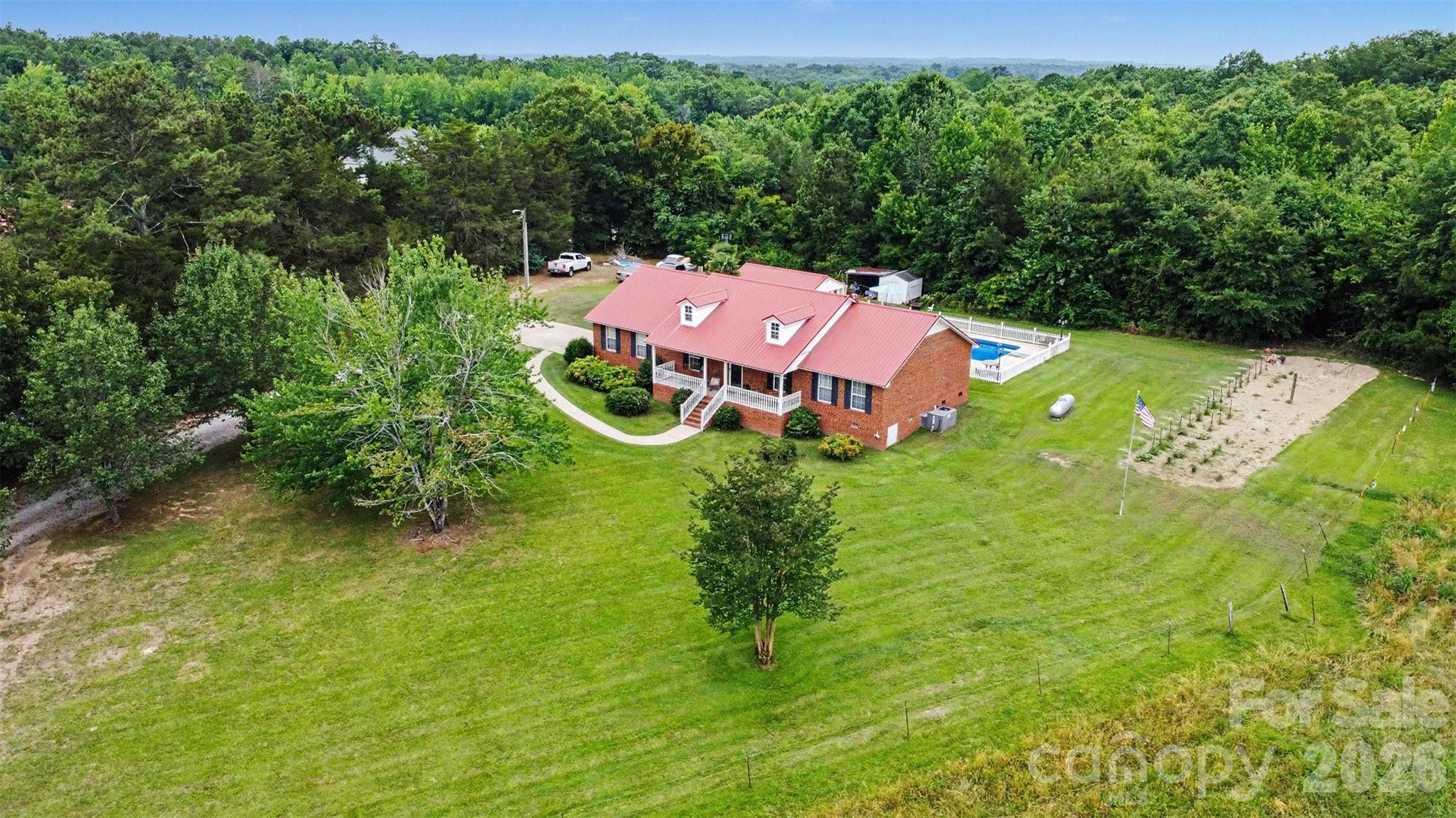 PRIVATE POOL ESTATE ON 9.47 ACRES | NO HOA | DETACHED BUILDING | ROOM FOR HORSES, HOBBIES & OUTDOOR LIVING

Rarely does a property offer this much usable land, privacy, and outdoor enjoyment at this price point. Situated on 9.47 acres in Lancaster County, this brick ranch combines the convenience of one-level living with the freedom to enjoy nearly 10 acres of open space, mature trees, recreation, and country living without sacrificing modern comforts.

The property offers ample space for horses, hobby farming, gardening, equipment storage, recreational vehicles, ATVs, boats, future workshops, or simply enjoying the privacy and flexibility of country living.

The home features spacious living areas, abundant natural light, and a functional floor plan designed for both everyday living and entertaining. The kitchen offers generous workspace and storage, while the main living areas provide beautiful views of the surrounding property.

Step outside and discover what truly makes this property special. The in-ground pool serves as the centerpiece of a private backyard retreat, complemented by expansive decking, outdoor gathering spaces, and endless room to enjoy the outdoors. Whether you're hosting family and friends, relaxing poolside, or simply taking in the serenity of your surroundings, this property delivers a lifestyle that is increasingly difficult to find.

The nearly 10-acre tract provides incredible flexibility for recreation, gardening, equipment storage, hobby farming, ATV trails, hunting opportunities, horses, or future expansion. A detached outbuilding offers additional storage and workspace, making the property as functional as it is beautiful.

With plenty of room to roam and a setting that feels miles away from it all, this property offers the privacy and freedom today's buyers are searching for. Properties combining acreage, a pool, usable land, outdoor entertaining space, and a move-in-ready home rarely become available.

Experience the space, privacy, and lifestyle that only 9.47 acres can provide. Schedule your private showing today.